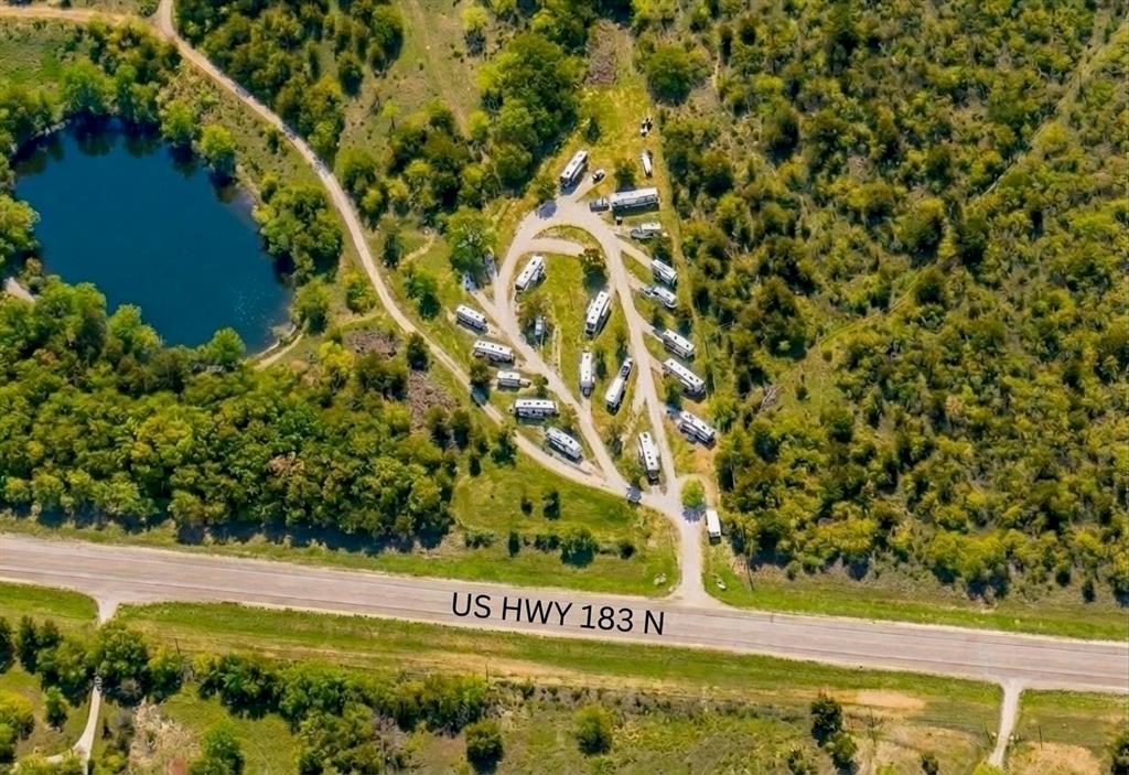 Income-producing RV park + unrestricted ranch with modern farmhouse and major development upside. Located at 7120 Hwy 183 N in Early, TX. This 103.6-acre property offers immediate cash flow with room to scale into a large RV resort.

Currently operating with 25 full-hookup RV sites at 80% occupancy, the park produced $50K NOI in 2025. Utilities are in place to expand with an additional 100–200+ sites in this high-demand Central Texas corridor. The property features 1,977 ft of Highway 183 frontage with excellent visibility, access, and commercial potential, just minutes from Early and 6 minutes to Brownwood amenities.

The modern farmhouse includes an open floor plan, vaulted wood ceilings, oversized island seating 8, custom cabinetry, farmhouse sink, double ovens with air fry, walk-in pantry, and a luxury primary suite with wet-room bath, cast iron tub, dual vanities, and custom closet. A 2,400 sq ft wrap-around porch offers scenic views. Ideal for owner, manager, or STR use.

Land features include peach & pecan orchards, hayfield, pasture, 3,500 ft (approx) of spring-fed Salt Creek frontage, and a 1-acre (approx) pond for fishing and recreation. Additional improvements include a 1,500 sq ft insulated barn or workshop with electricity and a 500 sq ft guest house or office shell ready for completion.

The property is rich with mature trees, wildlife, trails, and natural beauty. No restrictions or zoning allows for endless uses: RV resort expansion, homestead, hunting ranch, equestrian facility, event venue, or mixed-use development.

Turnkey income with significant upside potential.
