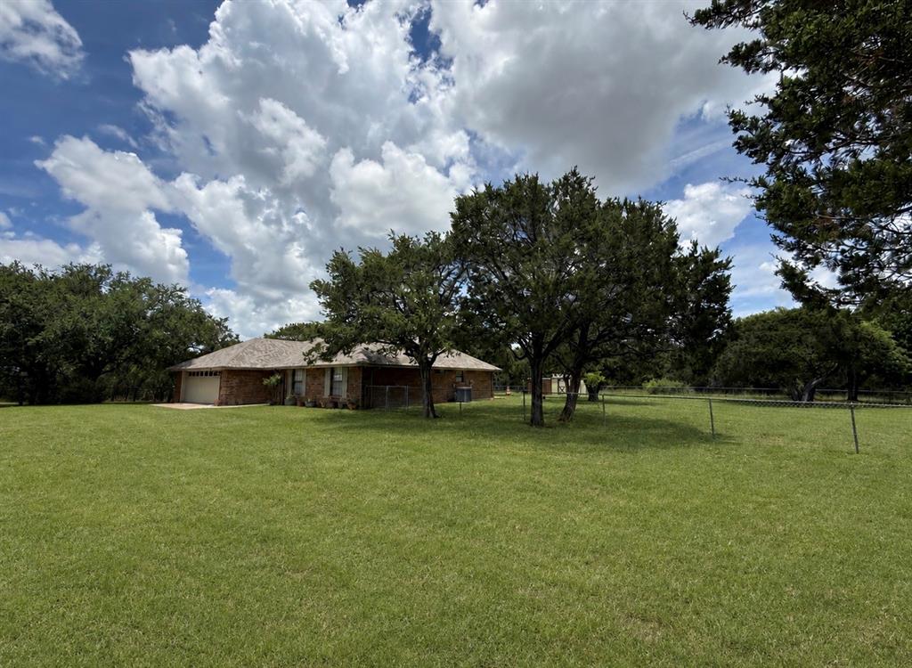 Spacious inside and out!  Just outside the city limits, this property offers  the peaceful feeling of country living while remaining conveniently close to town.  3B 2B split bedroom arrangement with large living room and a WBFP.  11X16 Office or craft room with cabinets next to primary bedroom.   Just wait til you see the enclosed porch that has an actual wood burning cookstove attached that the prior owner actually made her pies right there on the back porch-it is a really conversation piece.   All this on 1.3 acres and NO city taxes.   Ulrich storage building.  Aerobic septic and roof are 5 years old.  Kitchen appliances 4 years old.