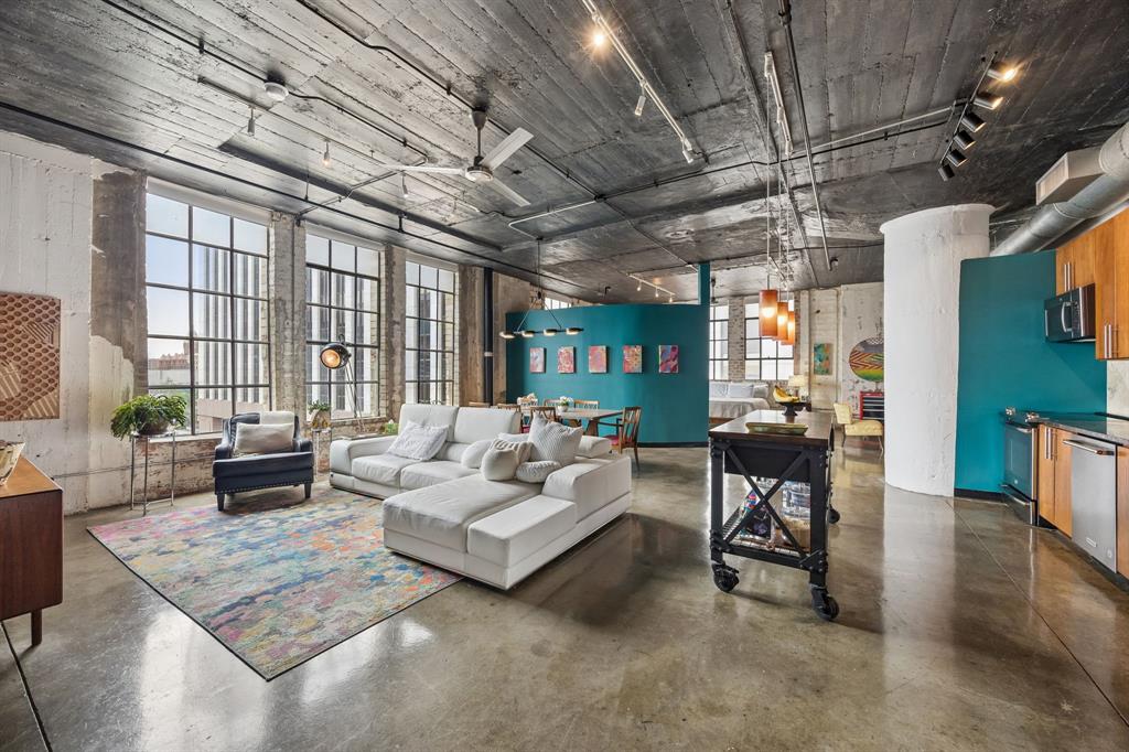 Rare corner-unit industrial loft with TWO assigned parking spaces! West-facing panoramic views of Reunion Tower, the Omni Hotel & Dallas's iconic bridges. Over 1,400 SF — one of the largest floor plans in the building. Loft character throughout: polished concrete floors, exposed brick, open concept layout & exposed ductwork. Privacy wall separates living area from bedroom & dual closets. Spa-like bath w-stone shower & Italian vanity. Kitchen features granite counters & SS appliances. Laundry storage room off entry. A rare find — don't miss it!