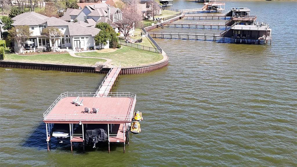 Experience the ultimate lakefront lifestyle in this sprawling open-water estate on Cedar Creek Lake, perfectly positioned just 75 minutes from Downtown Dallas. Designed for effortless entertaining and multi-generational living, this rare 6-bedroom, 5-bathroom residence offers the space and luxury required for large-scale hosting or peaceful family retreats.
The expansive floor plan features three distinct living areas, two fully equipped kitchens, and a private elevator for easy accessibility. Whether you are hosting a summer soirée or a quiet weekend, the home provides dedicated spaces for everyone, including a professional media room, a large gameroom, and a private home office. The current owners have cherished the home’s ability to comfortably accommodate three full families simultaneously, making it a true legacy property for children and grandchildren alike.
Outdoor living is the centerpiece of this estate. Enjoy spectacular views from the massive patio or head down to the premier boathouse, which is fully equipped to house two boats and two personal watercraft. Situated on a prime stretch of OPEN WATER, the property boasts a unique and picturesque vantage point directly across from the 15th tee of the prestigious Pinnacle Club Golf Course.
From high-energy water sports to serene sunsets over the greens, this home offers an unparalleled lake experience. Don’t miss the opportunity to own a premier piece of Cedar Creek Lake real estate.
The owners are also INCLUDING all furnishings, boats, and watercraft, making this an instantly useable lake house for your family with all the amenities ready to go!
Boat house is 30'X30', patio is 20'X44'.  Property has approximately 166' of lakefront, which is rare.
PRICE INCLUDES ALL WATERCRAFT, BOATS, FURNISHINGS -  EVERYTHING - DOWN TO THE LAST FORK AND SPOON.