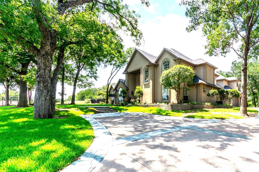 Argyle ISD, 6 Acres, Ag Exempt, Bring your horses, gated entry and idyllic country living with 2 barns, extended concrete parking, water well (no water bill), pipe on pipe fencing, property is bordered by creeks on 2 sides.  This home has hand scraped hardwood floors, granite and quartz countertops, separate ice maker, instant hot water dispenser, 2023 refrigerator.  There are animal stalls and poultry coops.  4 bedrooms with an office that could be a 5th bedroom.  The oversized 3 car garage has an air conditioned workshop.  Heated pool and spa with smart lighting system and timers you can control from your smart phone.  The yard around the house has a full sprinkler system.  FIOS internet.