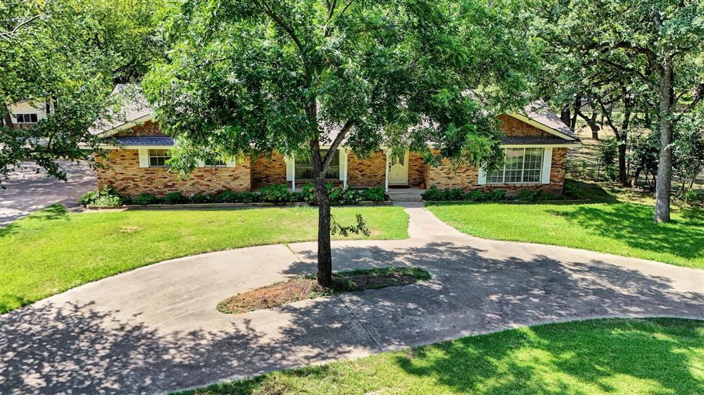 Country in the city!  Bring your horses!  Your dream country home is waiting! This unique 2.84 acre wooded property is located in Irving within close proximity to DFW International Airport with easy access to Airport Freeway and other major highways.  The 2146 sq-ft home sets on a quiet circle within the City of Irving.  It has 3 bedrooms, 2 full baths and 1 half bath; two-car attached garage. The spacious kitchen with breakfast nook adjoins the family room with a large brick fireplace.  It has a formal dining area and additional living area combined.  The patio looks out upon large Texas oaks in the back yard.  Plenty of room for relaxing or entertaining.  Behind the house sets a 1200 sq ft, 3 car garage with finished interior.  This building could easily be converted into a family party area or office space with single car garage and kitchen.  Next door to this building is a very nice 1792 sq-ft workshop or storage building, whichever you choose, also with a garage door entry. Additional highlights of this property include easy access driveways, oversized windows throughout the home, sprinkler system, irrigated garden area, as well as other storage units on the property, energy efficient home, lots of cabinetry throughout the house, and the best neighbors you could ask for.  Horses are permitted on this property as well as all the chickens you want.  All of this is just minutes from major highways, shopping, dining, and everyday conveniences.
In addition to this property, the 2.29 acre lot next door is owned by the same family.  It  has a 2 bedroom, 2 bath home and will also be offered for sale in the near future. Buyer's Agent is responsible to verify room sizes and schools.