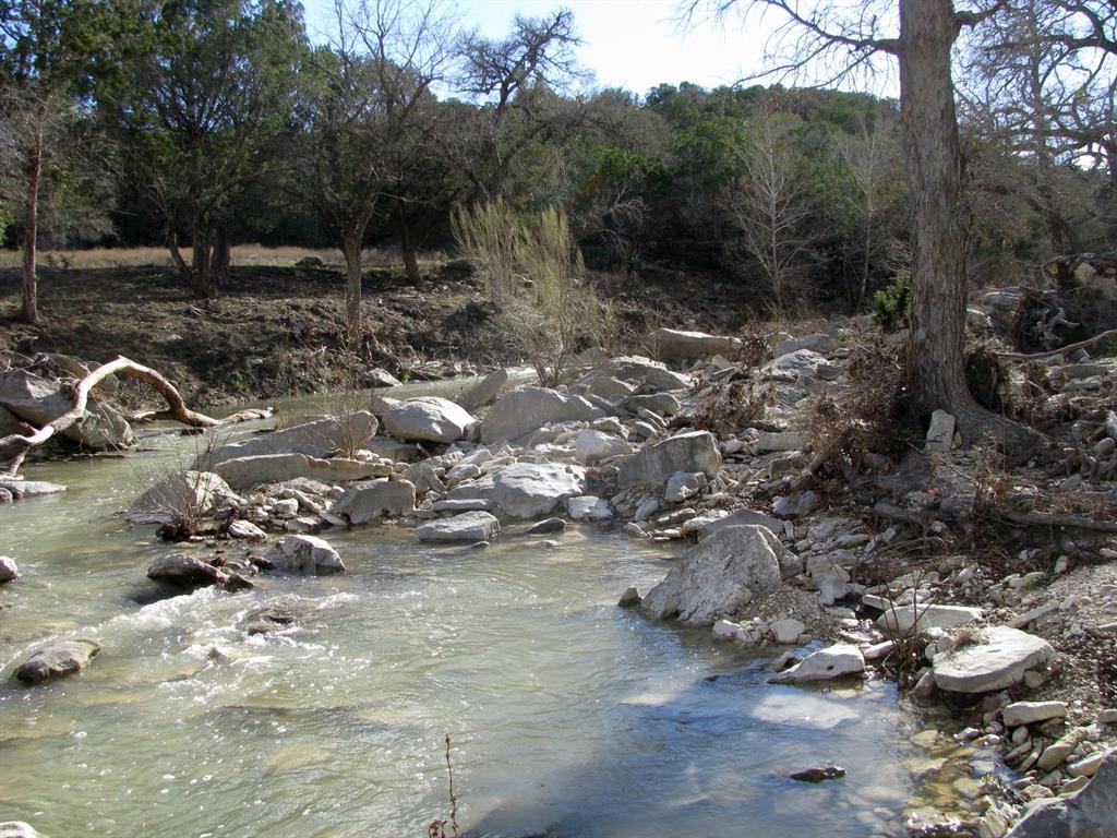 This 5.01-acre tract is located in the gated Buffalo Creek Subdivision, known as lot 63, offers a peaceful setting with paved roads, rolling terrain, and a mix of mature trees. The property features frontage along Langford Creek, providing a scenic and serene backdrop ideal for a homesite or weekend retreat. Electricity and high-speed fiber optic internet are available, and a private water well will need to be drilled. Centrally located, this property is just 30 minutes from Hamilton, Lampasas, and Gatesville, and about an hour from Waco and Stephenville, making it a convenient escape with easy access to surrounding towns. Whether you're looking to build your dream home or invest in land with natural beauty and modern infrastructure, this property presents an excellent opportunity in a well-maintained rural community.