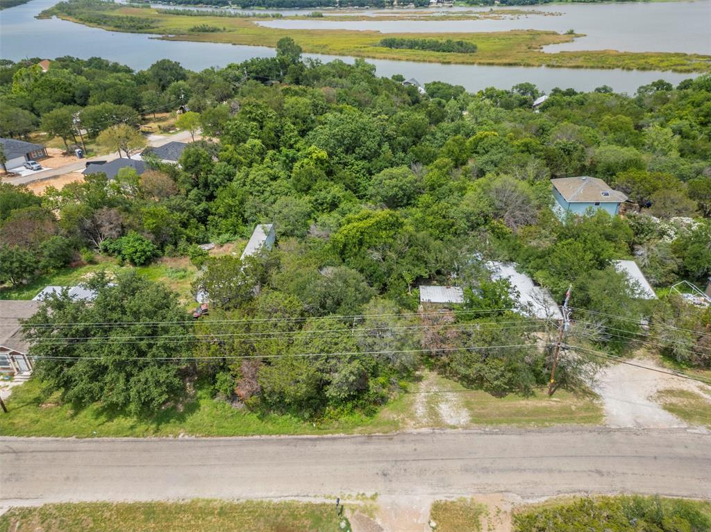 Sensational Vacant Residential Lot in Amenity-Packed Community! Situated in the extremely popular community of Oak Trail Shores, this 0.142-acre lot offers comfortable surroundings with a wide variety of possibilities. Choose to build a brand-new single-family home or opt for a beautiful new manufactured home. Position your new residence for maximum outdoor benefits. Construct an entertainment-friendly deck, plant lush knockout roses, and even install a hot tub for relaxing evening soaks. If you are seeking a community with tons of healthful activities, look no further. Enjoy the sparkling community pool, two playgrounds, basketball court, soccer field, community center, fishing pier, and three boat ramps. Take a quick drive to Downtown Granbury, and explore the local restaurants, boutiques, entertainment venues, recreational opportunities, and golf courses. Investors and homebuyers alike are sure to relish in this unique community’s offerings. Private seller fin. is available with large down payment for deserving borrowers.