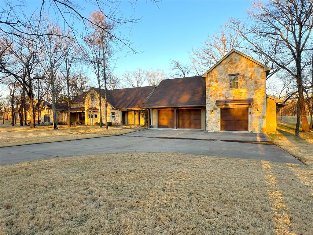 Exceptional golf course living in the prestigious community of The Links at Land’s End, located on a peninsula of the world-famous Lake Fork known for incredible bass fishing. This stunning 3 bedroom, 3 bath home with a dedicated office offers 2,606 square feet of thoughtfully designed living space and sits on a rare double lot shaded by beautiful mature oak trees.

Positioned on the 18th tee box, the property enjoys picturesque views of the tee, pond, and fountain, creating a peaceful yet vibrant golf course setting. The sprinkler system draws water directly from the pond, offering significant savings on summer water bills.

The home features a timeless Hill Country exterior with rock, stucco, and board and batten accents. Inside, you’ll find high ceilings, large timber beams in the living area, an open-concept layout, granite countertops, walk-in closets, and quality finishes throughout.

A breezeway connects the home to a spacious three-car garage, which includes an upstairs area that could be finished out for additional living space, guest quarters, or a game room.

Just a short distance to the clubhouse, residents enjoy access to golf, dining, and a variety of clubs and social activities. This is a rare opportunity to own a premier golf course property in one of Texas’ most sought-after lake communities.
