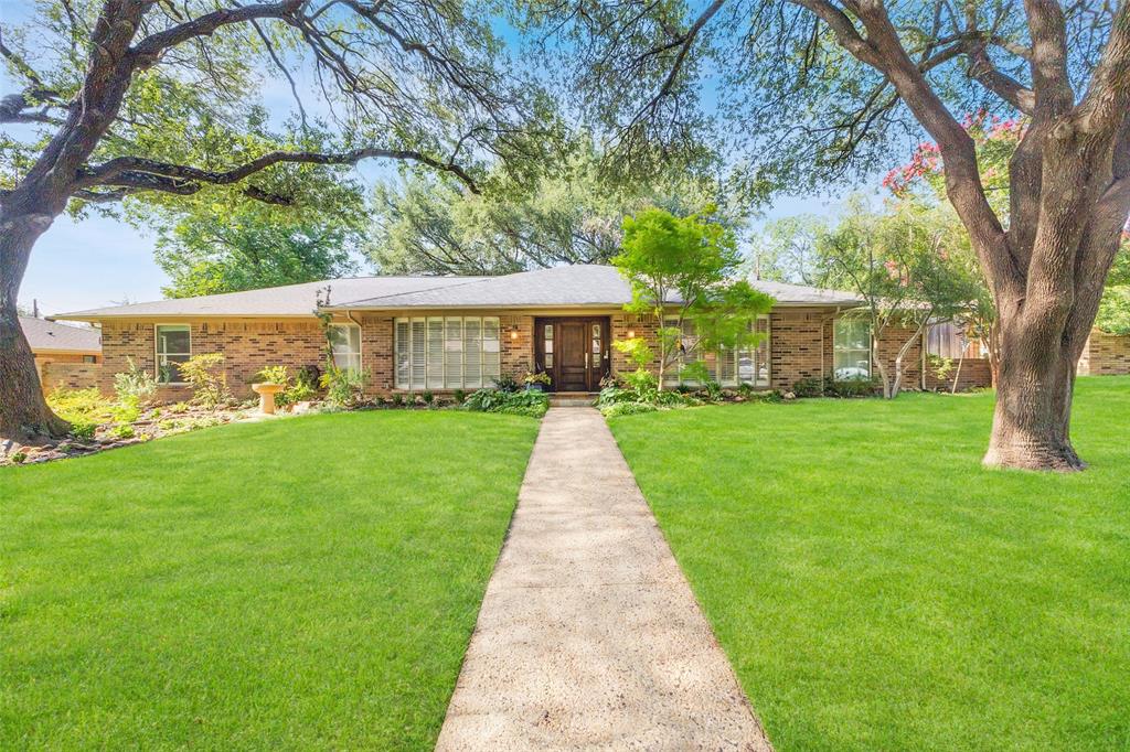 Location, floorplan, and condition come together in this well appointed, one-story home situated in the private school corridor east of Midway! Magnificent, towering oak trees and lush landscaping create an enchanting and inviting drive up. The interior offers spacious living spaces, wood & travertine floors, vaulted ceilings, skylights, LED lighting, plantation shutters, and spectacular views of the turfed and landscaped backyard. Generously sized living room and dining room lead to the vaulted ceiling den offering a fireplace with gas logs, access to the living patio, and open flow to the kitchen & breakfast room. The kitchen provides a center island, breakfast bar, custom designed ceiling-height cabinets with abundant storage, and top appliances including a gas range & stainless steel dishwasher, microwave, and refrigerator. The adjacent breakfast room offers additional dining space and a handsome built-in hutch with glass-front cabinets. Beyond the kitchen sits a versatile bonus room—ideal for a home office, exercise space, or hobby room, paired with an adjacent half bath. The primary suite is a true retreat with wood floors, oversized closet, access to the back patio, and a luxurious updated bath offering a double marble vanity, jetted tub, and oversized shower with frameless glass enclosure. Enjoy morning coffee or evening wind-downs on the slate back patio while taking in the bucolic, turfed backyard surrounded by a board-on-board fence for privacy. Other amenities include an epoxy-floored 2-car attached garage with A+ storage, back driveway space for basketball or extra parking, sound-system wiring, 2022 roof, and replaced sewer line! Zoned to acclaimed Withers Elementary! Stellar location convenient to top private schools + shopping and dining spots of Preston Hollow!