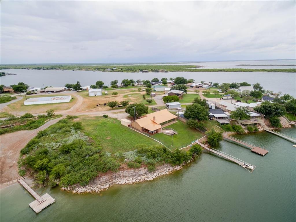 Lakefront living at its best. This updated 1980 ranch-style home is located on Lake Kemp in the gated Moonshine community adjacent to the Waggoner Ranch. The home features two en-suite bedrooms, a wet bar, and a sunroom with excellent lake views. Recent improvements include a brand new metal roof (2024), updated interior finishes, and a brand new dock.

Outside offers new fencing, a covered back patio, and an attached garage with overhead doors on both sides—ideal for pull-through access, lake equipment, or additional recreational space. The property also includes a connex with electricity already installed for extra storage or workspace. Hot tub conveys with the property.

This is a long-term leasehold property with land leased from the WT Waggoner Estate. The 2026 lease has already been paid. Buyers must be approved and pass a background check through Waggoner Ranch Estates.

A well-maintained lake property with strong improvements already in place and outstanding water views.
