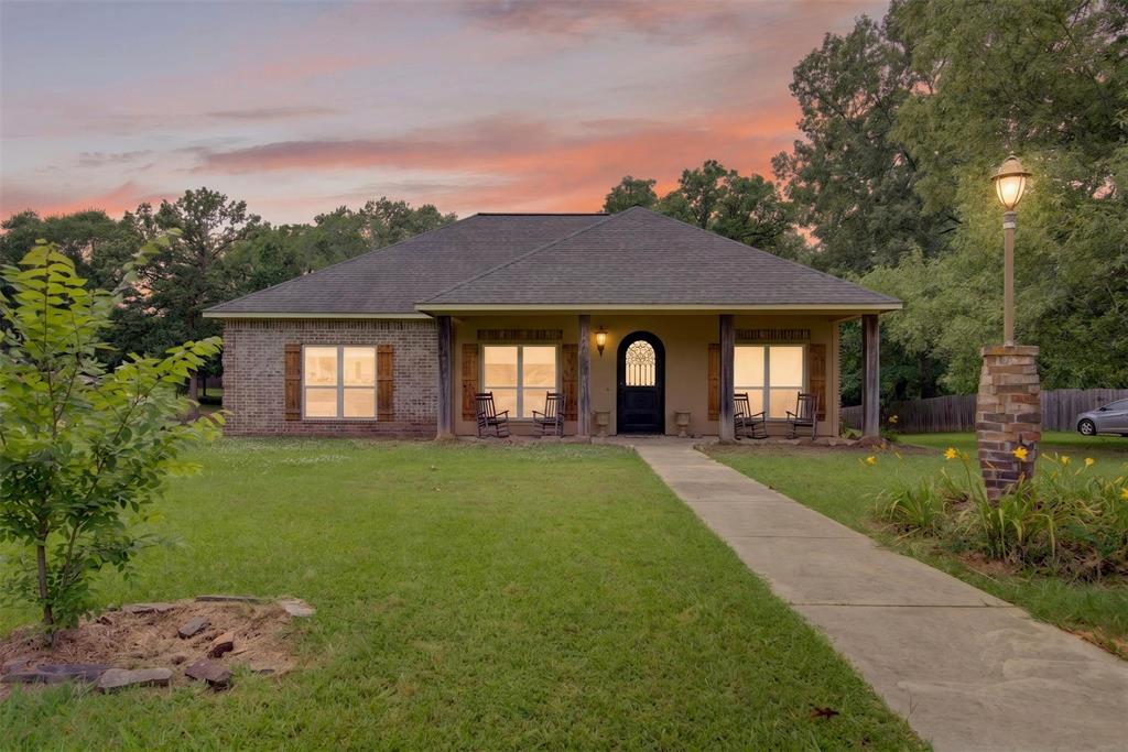 This beautiful home is located in the serene community of Pelican Place in Stonewall. Built in 2014, this residence spans over a nearly 1-acre lot and features 3 bedrooms, 3 full and one half baths, and a generously proportioned two-car garage.

Inside is an inviting open floor plan, featuring a living room adorned with bamboo wood floors and a cozy wood-burning fireplace, seamlessly connected to the breakfast room and granite-accented kitchen. The formal dining area offers a separate setting for entertaining.

The remote primary en-suite has two walk-in closets, dual sinks, a jetted tub, and a spacious walk-in shower. Two additional downstairs bedrooms, each with their own walk-in closets.

Venture upstairs to discover a versatile bonus room, complete with a full bath and closet, perfect for guests or flexible living space needs. Utility is at the forefront, with a dedicated laundry room featuring a sink and cabinetry to simplify daily chores.

Outside, enjoy the tranquility of the covered front and back porches as you overlook your sprawling grounds. The extra-long garage provides ample storage, while the above-ground pool offers a refreshing escape during warm summer days. Brick floors in the downstairs bathrooms and granite countertops enhance the home's timeless appeal.