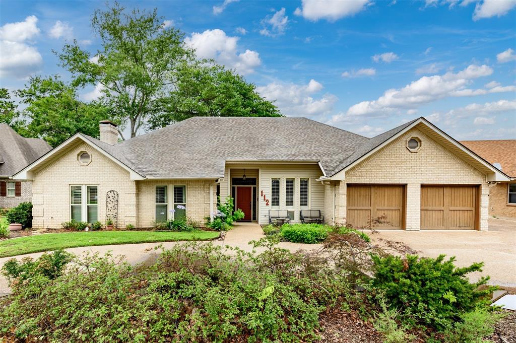 Waterfront living at its finest in the prestigious Emerald Bay gated golf course community, near Tyler, on beautiful LakePalestine! Situated on a mature tree-shaded, fenced lot with 125' of bulkheaded shoreline, this spacious 2,850 sq. ft. home offers 3 bedrooms, 2.5 baths, stunning lake views, & exceptional outdoor amenities. A circular drive provides ample guest parking & welcomes you to the attractive herringbone brick entry. Just inside, a private office with wainscoting & sliding wood doors creates the perfect workspace. The heart of the home is the light-filled open-concept living, dining, & kitchen area designed for comfortable everyday living & entertaining. A floor-to-ceiling stone wood-burning fireplace with hearth & built-in cabinetry anchors the living room, while a wall of windows showcases beautiful views of the landscaped backyard & lake. The dining area includes a built-in corner cabinet for display & storage. Heavy-duty sliding doors open to the covered patio with remote-control shades & sidewalk leading to the boathouse. The kitchen features an island, breakfast bar, stainless appliances incl. a brand-new refrigerator, dishwasher, cooktop, built-in oven & microwave. Washer, dryer, all appliances, &new commercial-grade recirculating water heater convey. The private primary suite overlooks the lake & includes sitting area, built-in bookshelves, & direct access to the covered patio. The ensuite bath offers double sinks, a large shower with seat, & separate closets with built-ins. Enjoy endless days on the water from the boathouse with three electric lifts, covered deck space, storage, refreshment area with roll-up window, & even a catfish feeder. A two-car garage plus two golf cart storage areas provide excellent flexibility - one space ideal for a workshop. Emerald Bay amenities incl. a clubhouse with indoor & patio dining, 18-hole golf course, marina, boat launch, fishing pier, pool, tennis and pickleball courts, basketball court & playground.