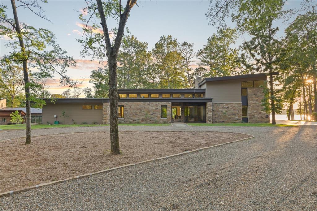 Stunning home on Bob Sandlin! Located in Lost Pines, this custom home is positioned on one of the most gorgeous, oversized lots on the lake and offers some of the best views you’ll find. Completed in 2026 by one of the area’s most respected builders, Copeland Construction, this home was thoughtfully designed with exceptional attention to detail throughout. From the moment you walk through the door, craftsmanship and quality are undeniable. Designed with lake living in mind, the open living and dining area is filled with natural light and showcases breathtaking water views through walls of windows. Double sliding glass doors and operable front windows allow the lake breezes to flow through the great room. The living area features soaring ceilings and a beautiful gas log fireplace. The kitchen is a dream, featuring Taj Mahal Quartzite CT, Wolf range, SubZero refrigerator, two Bosch dishwashers, and one of the largest islands you’ll find. The wet bar area is equally impressive with Monogram wine and beverage coolers. The oversized pantry also serves as a storm shelter engineered to withstand F5 tornadoes. The home offers four bedrooms plus an additional bonus room currently utilized as an office. Primary suite is a luxurious retreat with stunning views, electric shades, and a spa-like bathroom with WI closet. An additional guest suite with private bath is located downstairs. Upstairs features a second living area with workspace along with two additional bedrooms and full bath. Outdoor living space is nothing short of spectacular. The huge covered patio flows seamlessly from the kitchen and living area and is designed for year-round enjoyment with an outdoor fireplace, built-in grill, heaters, ceiling fans, and electric retractable screens.Boathouse features metal piers, two slips and two storage closets. Additional features- whole-home generator, garage wiring for electric vehicles, and infrastructure already in place for solar capability. Sold with most furnishings.