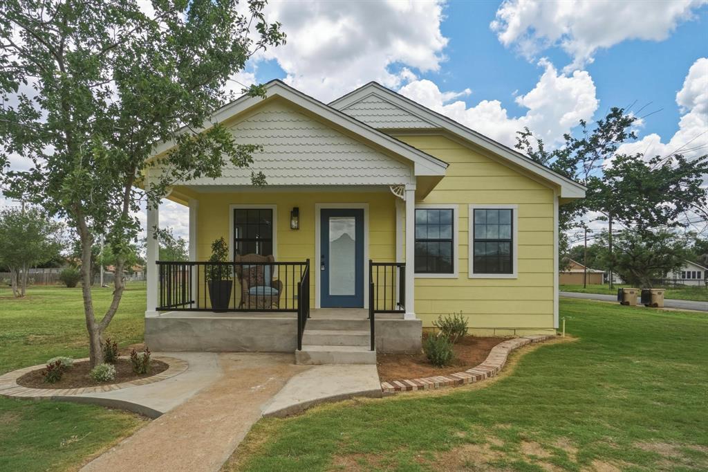 Welcome to the charming Yellow Rose house at 111 Rose in Merkel, Texas where timeless character meets modern convenience. This beautifully remodeled 2 bedroom, 2 bath home has been taken down to the studs and thoughtfully rebuilt with attention to every detail. Major updates include new plumbing, electrical, HVAC, roof, paint, windows, and so much more, giving buyers peace of mind while preserving the home's unique charm.
Inside, you’ll fall in love with the blend of shabby chic style and antique inspired touches throughout. From the stylish blue painted floors paired with original hardwoods to the crisp white walls that brighten every space, this home feels warm, inviting, and full of personality. Both bathrooms feature stunning tiled walk in showers with elegant glass doors. The kitchen is truly one of a kind, combining vintage charm with modern flair. Crisp white cabinetry paired with black hardware creates a clean and timeless look, while the patterned tile backsplash adds warmth and character. Stainless countertops give the space a unique industrial touch, beautifully balanced by the soft shabby chic style throughout the home. Natural light pours through the oversized windows. The mudroom offers the perfect blend of style and function, featuring eye catching reclaimed wood accent walls, crisp white trim, and those signature soft blue painted floors. There is also room for a stackable washer and dryer, making this area ideal for a practical laundry space without sacrificing charm or character. Outside, the property includes a detached garage with electricity perfect for parking, extra storage, a workshop, or hobby space. A new survey will be needed.