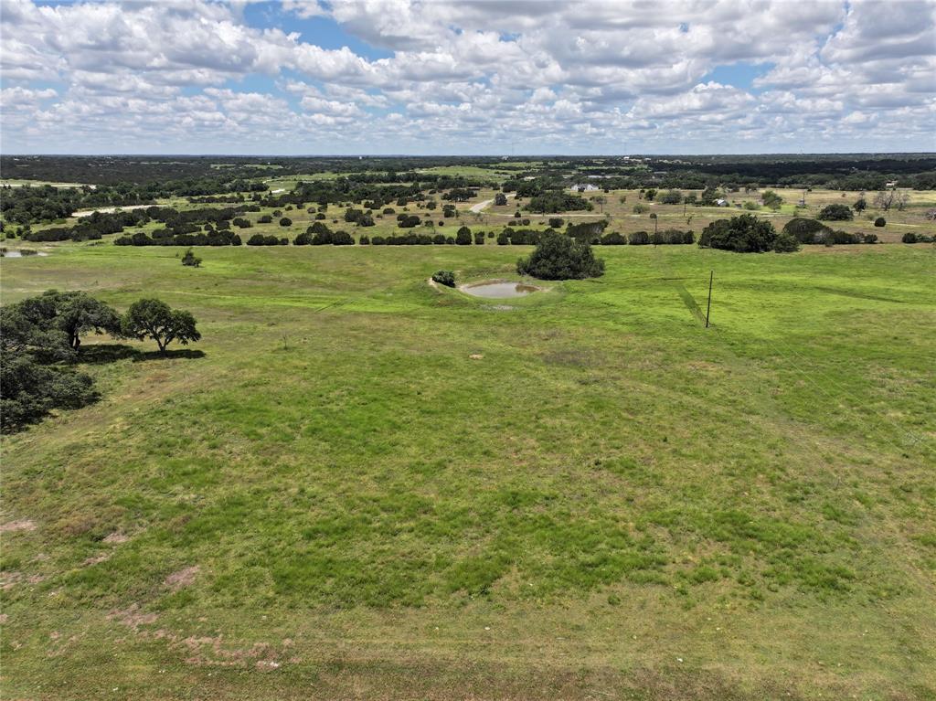 Beautiful lot waiting to fulfill your custom-built home! Located in a peaceful country setting along with a community of luxury homes. Gaze out at the scenic Texas landscape by day and the abundant stars at night. Bring your dreams and builder to design your special layout on this spacious 5 acre property. Watson Place offers a unique ag-exemption program allowing a community grass lease, for more information see their deed restrictions.
