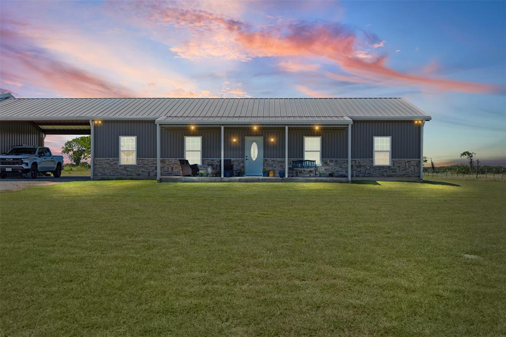 Rare opportunity to own a custom-built barndominium on 3.7 gated, fully fenced acres outside the city limits—complete with an incredible 30x40  workshop-garage, additional storage building, & room to enjoy country living. Built in 2016 by its original owners, this thoughtfully designed one-owner home offers comfortable everyday living with the functionality and flexibility that's becoming increasingly difficult to find. Enjoy lower property taxes just minutes from Waxahachie. Inside, the open-concept layout features a cozy living area, dining room, & well-appointed kitchen with a propane gas range, abundant cabinetry, generous counter space, & a large laundry room with additional storage. The private primary suite on the opposite side of the home offers a walk-in closet and ensuite bath, while three additional bedrooms occupy a separate wing with a spacious game room ideal for a second living area, home office, or media room. Built for efficiency, the home features spray foam insulation, a propane tankless water heater, and impressively low utility costs. The 30x40  workshop-garage features electricity, concrete floors, three oversized bay doors, & built-in pallet racking, providing exceptional space for vehicles, ATVs, equipment, storage, or projects. A separate 18x21 storage building offers even more room for tools and lawn equipment. A covered breezeway provides two-car parking and connects the home to the impressive workshop. Outside, enjoy an automatic solar-powered gated entrance, full perimeter fencing, a dedicated chicken coop, covered front porch, expansive back patio, & plenty of room for horses, livestock, gardening, recreation, or simply relaxing. At just $499,900, opportunities like this are becoming increasingly rare. Finding a custom-built barndominium on 3.7 gated acres with a workshop of this caliber, multiple outbuildings & the freedom of country living just minutes from town is hard to beat! Don't let this opportunity pass!