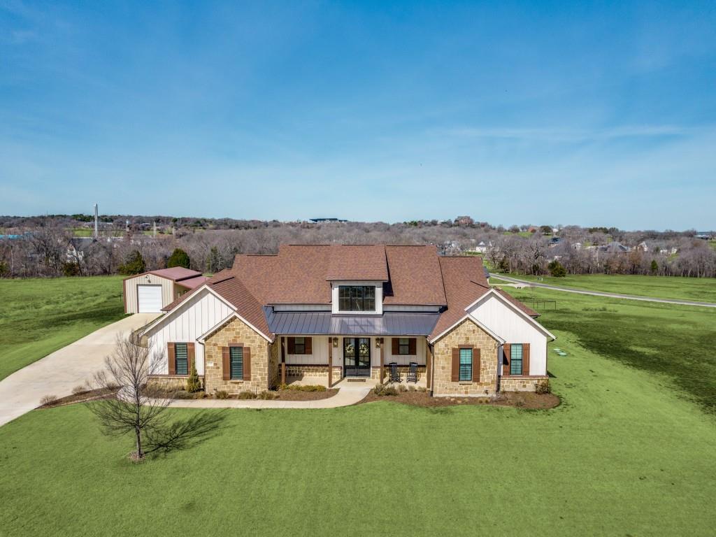 Starry skies and breathtaking sunsets await at this custom built retreat on 2 acres in the prestigious estates of Newsom Ranch. Designed for both everyday comfort and unforgettable entertaining, this home offers refined finishes, thoughtful upgrades, and stunning views from every angle. Impressive double entry doors welcome you with an abundance of natural light. Elegant ceramic tile flooring flows seamlessly into the expansive living and dining areas. A striking gas fireplace with custom mantle serves as the focal point, while vaulted ceilings accented with a wood beam create warmth and architectural charm. The Chef's Kitchen is truly exceptional, featuring a six-burner cooktop, double ovens, and oversized island with prep sink and bar seating. A walk in butler's pantry with custom cabinetry and hidden microwave adds style and function. Leather-finished granite, custom backsplash, beautiful pendant lighting, and a farmhouse sink framed by windows overlooking the acreage elevate the space even further. The spacious primary suite is a private sanctuary with patio access for peaceful evenings under the stars. The luxurious en suite bath features double vanities, freestanding soaking tub, and a walk-in shower. Split bedrooms provide privacy for all, and the fourth bedroom, complete with en suite bath, makes an ideal guest suite, craft room, or mother-in-law retreat. Working from home is effortless with both an AV office and an additional library office, offering multiple workspaces. Even the laundry room impresses with custom cabinetry, utility sink, brick tile flooring and direct access to the primary closet. A Bonus Feature is the 20x30 Insulated Workshop with 10x10 roll-up door, mini-split climate control, and ample 110 and 220 electrical service, perfect for hobbies, projects, or additional storage. Enjoy morning coffee on the extended covered front porch or unwind on the back patio, taking in the panoramic views. This is the Dream Retreat you've been waiting for!