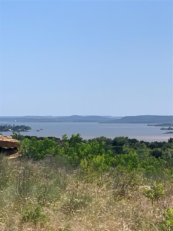This beautiful two acre lot, located at the end of a cul-de-sac on one of the more elevated streets in The Hills Above Possum Kingdom, offers awe-inspiring view of gorgeous sunsets over PK Lake.  Situated almost at the end of a cul-de-sac with a slight uphill terrain, you can truly see nature's artwork for miles!  A variety of native trees, flora, and fauna dot the surface, leaving plenty of room for adding the lake home of your dreams.  There's no time requirement for starting to build, so until you're ready, you can enjoy the land in its natural state and still have access to the many amenities available to HAPK property owners.  The gated community boasts a beautiful infinity edge pool, fitness center, conference center, lakeside cabin for events, private boat launch, courtesy dock with slips, dry boat storage, fishing ponds, picnic areas, and more!  An affordable owners association with minimal restrictions ensures an appealing residential neighborhood. (no temporary or manufactured homes allowed; minimum home size 2,000 sq ft) The Hills is a great place to get away from the city and experience local wildlife - turkey, fox, rabbits, birds galore, spend some time on the lake, or create a wonderful place to call home.  Come see if lot 616 Caprock Ct is the right fit for you!