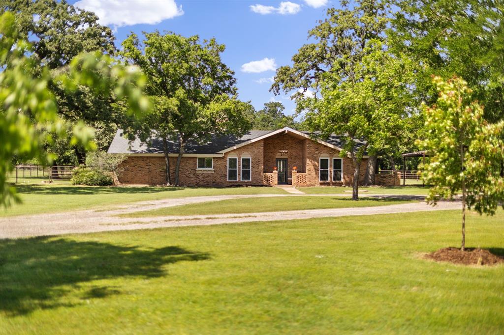 Looking for a small acreage with a home? This ranchette is it—country living at its very best, tucked away at the end of a quiet street surrounded by mature trees. The natural tree canopy and a Cul de sac setting creates a sense of seclusion and privacy that feels worlds away from the hustle of the city.The single-story home offers 3 bedrooms and 2 full baths with a light and bright open floor plan and a stunning see-through stone wood-burning fireplace. The kitchen features custom-built cabinets, generous counter space, and an island with a cooktop—perfect for entertaining. The spacious master suite includes two separate vanities and two large walk-in closets. A split bedroom arrangement adds privacy for the whole family. Fresh ceramic tile runs throughout the entire home.  A giant mud room with plentiful built-in storage is an absolute game changer for ranch living — the perfect landing zone for boots, barn jackets, feed gear, and all the tools of daily ranch life, keeping everything organized and the rest of the house clean. Seller updates include high-efficiency windows, AC unit, a septic system, an electric panel — giving you peace of mind and move-in ready comfort. Outside, the cross-fenced layout includes multiple pastures, a 3-horse stalls lean-to, and a small barn with a dedicated feed room and a separate goat stall — everything you need to run a small operation or simply enjoy the animals you love.
This 2.5+ acres sits outside city limits in the ETJ, meaning no city taxes, no HOA, no deed restrictions, and no zoning. Use it as a private residence, a home-based business, or both — the freedom here is real.
And yet convenience is never far. Just minutes away you'll find Walmart, Kroger, Target, Lowe's, and the upcoming HEB on 380, along with Omni PGA Frisco, downtown Denton, UNT, TWU, and everything the DFW metroplex has to offer.
The perfect blend of country serenity and city convenience — this ranchette is a rare find. Come see it for yourself.