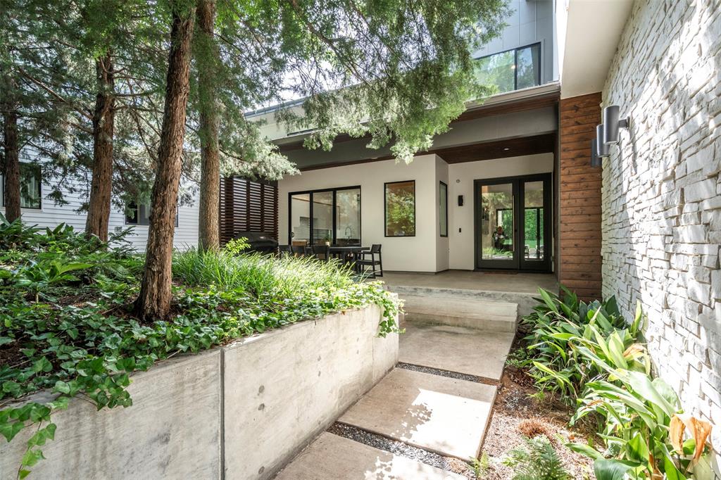 Welcome to 8020 Forest Trail, a beautifully designed 5-bedroom home located in one of Dallas’s most desirable neighborhoods served by White Rock Elementary. The primary bedroom is on the first floor, offering convenience and privacy. A second bedroom downstairs is currently set up as a home office, providing flexibility for various needs.

The home sits on a lot that offers rare privacy, surrounded by mature trees that create a peaceful, secluded atmosphere. Its placement makes you feel miles away from the city while being right in the heart of Dallas. You’re also just minutes from Flag Pole Hill and White Rock Lake, providing easy access to outdoor activities.

The backyard is built for relaxation and entertainment, featuring a pool, hot tub, spacious lawn, and a covered patio with phantom screens for year-round enjoyment.  Smart lighting throughout the home adds to the modern convenience, and the two-car garage is equipped with an electric charger. The front yard also features a firepit and sitting area, ideal for gathering with friends and family.

Upstairs, a game room offers additional living space to meet your family’s needs. With quality finishes, thoughtful design, and a prime location
