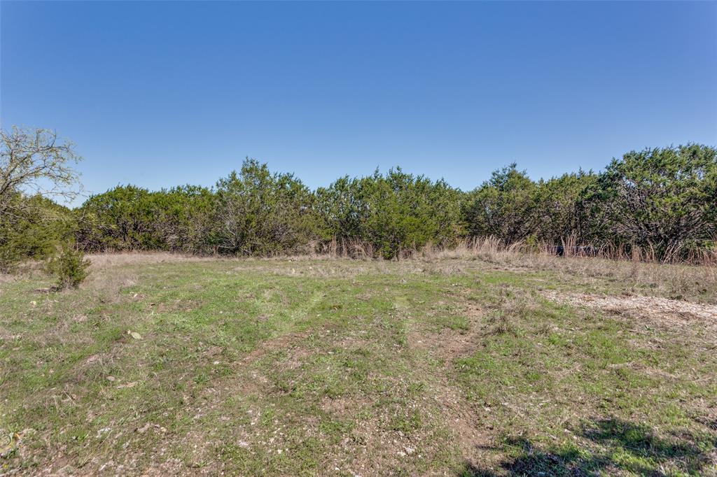 Discover the perfect blend of peaceful country living and everyday convenience with this beautiful 2.5-acre property in Cleburne, Texas. Nestled among mature trees and offering scenic views, this land provides the ideal setting to build your dream home or weekend retreat. This is 1 of 2 lots for sale. Please see MLS#21218090 for Lot 1 info. Seller prefers to sell together! Section of land has been cleared for a potential build. Enjoy a paved road frontage and easy access, getting to and from the property is effortless. Electricity access is at the street. Just minutes from outdoor adventures at Cleburne State Park, where you can hike, fish, and unwind in nature, while still having quick access to major roads for an easy commute. Chisholm Trail Parkway is close by. Whether you’re envisioning a custom-built home, a barndominium, or a manufactured home, this property offers the flexibility to bring your vision to life. No HOA. Experience the tranquility of wide-open spaces without sacrificing convenience this is your opportunity to create the lifestyle you’ve been dreaming of. Well and septic will need to be installed. Survey is available.