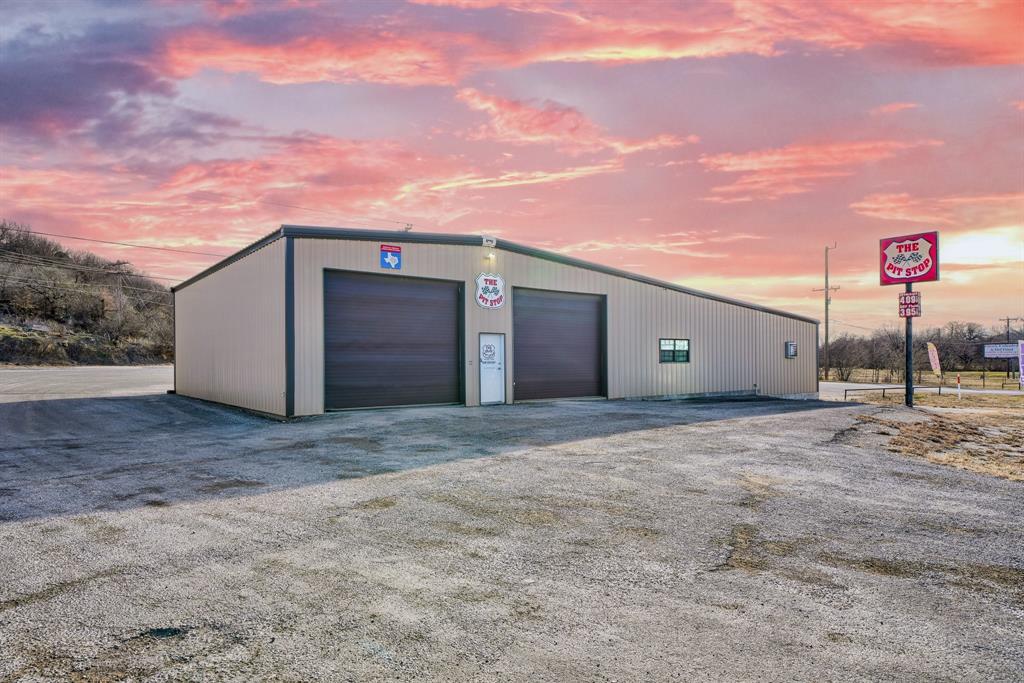 Amazing business opportunity located just outside of downtown Graham, TX! Sitting on 1.3 acres, this 4,732 square foot building currently serves as an Oil Lube and Service station.  Offering two large, pull-through service bays, a private office, a waiting room for customers, a bathroom and an additional storage area, this property is in a prime location and ready to go!