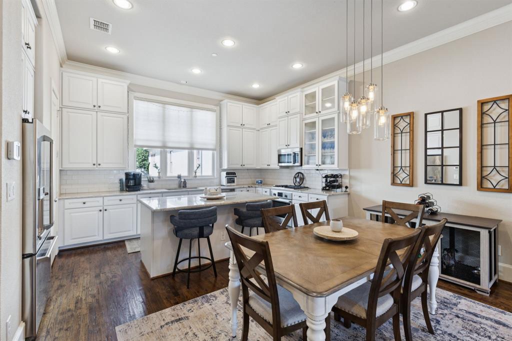 Enjoy skyline views and unbeatable walkability in this ECO-HIP 4-story townhome, ideally located in the heart of Dallas. This beautifully crafted brownstone, reminiscent of classic Brooklyn style, sits just steps from the Farmers Market, Downtown Dallas, East Quarter, and Deep Ellum, offering the ultimate urban lifestyle.

Built in 2014 with quality construction, this home features a spacious floor plan, soaring ceilings, plantation shutters, and hardwood floors throughout. The bright, modern kitchen is a standout with its light aesthetic, River White granite countertops, Bosch appliances, walk-in pantry, upper cabinet storage, and large center island, perfect for entertaining.

The private primary suite offers a tranquil retreat with walk-in closets, a jetted tub, and an oversized walk-in shower. Relax or entertain on your private rooftop deck with breathtaking views of the Dallas skyline or enjoy a peaceful morning on your personal balcony.

Attached 2-car garage. Street parking available in front, plus access to a fantastic community pool just one block away. Live in the heart of it all—with restaurants, nightlife, and culture at your doorstep.