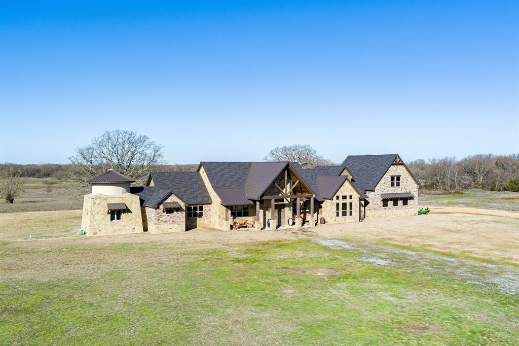 2-story brick home built in 2020 has everything you could want 3200 square feet first floor & 610 square feet second floor. Large foyer, living, dining all connected for an amazing open floor plan. Living room has a floor to ceiling stone wood-burning fireplace with custom wood mantle & stone hearth. There are plenty of windows along the east wall to let in natural light & wood look concrete floors for a warm and inviting feeling. Eat-in kitchen has beautifully placed island with knotty alder cabinets & granite countertops and has slate stainless appliances including a gas range that will convey. Primary bedroom has vaulted ceilings & an ensuite bathroom which has a walk around private shower, dual sinks, separate walk-in closets & a garden tub. Guest bedrooms have stained concrete floors, windows for natural light & nice size closets.  There is a reading room attached to the primary, wet bar, and a coffee station! The home is a complete custom home, with ample amounts of antique wood!