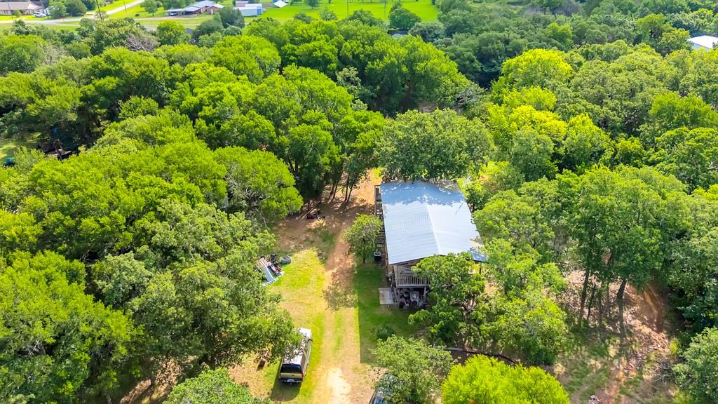 Discover the possibilities on this scenic property with no HOA and no known deed restrictions. Whether you're looking for an investment opportunity, a place to renovate and restore the existing log cabin-style home, or the perfect setting to build your custom dream home, this property offers flexibility and potential. Surrounded by the beauty of rural living, you'll enjoy open space, privacy, and room to create the lifestyle you've been dreaming of. The existing home provides a starting point for those with a vision, while the land itself offers numerous opportunities for future use. Conveniently located with easy access to nearby amenities while still maintaining a country feel. Buyer to verify all information, including schools, utilities, and any applicable restrictions.