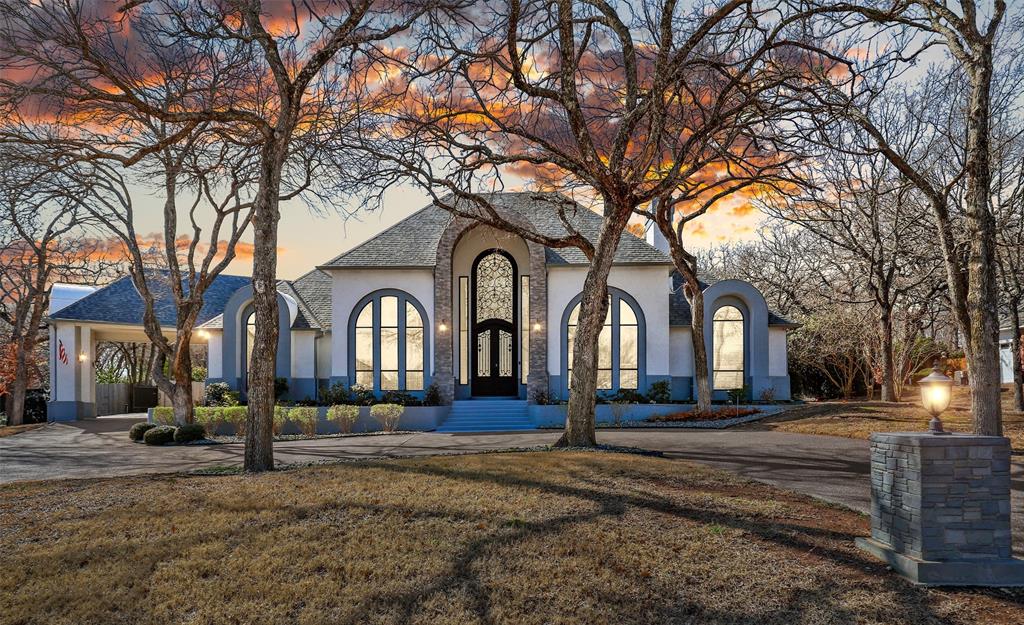 COMPLETELY RENOVATED 1.5 STORY KEN HODGE CUSTOM ESTATE WITH A PRIVATE IN-LAW SUITE & BACKYARD PARADISE NESTLED ON AN ACRE! Car & hobby enthusiasts will love the gated driveway with a porte-cochere leading to the oversized 5 car garage plus the detached 6 car, 1,200 sq. ft., garage providing a great workshop. Surround yourself in the luxury of this CEO lived in home boasting a high-tech security system, extensive handscraped Brazilian cherry wood flooring, custom wrought iron & glass front door, 22' barrel vaulted ceiling, fresh paint, custom wine cellar with a built-in wine cooler, 2 fireplaces & breathtaking views from most rooms, plus tons of windows & skylights flooding the home with natural light. The chef's kitchen features granite countertops, soft close drawers & cabinets, GE Profile appliances, a gas range with a griddle, 3 ovens & a built-in breakfast table. Pamper yourself in the lavish primary suite showcasing a sitting area with a coffee bar & built-in wine cooler, an oversized semi-frameless shower with a rain shower head & handheld sprayer, a dual sink granite vanity, makeup area, soaking tub, 2 huge custom closets & a safe room. Make great use of the in-law suite graced with a separate entrance, kitchen with granite counters & stainless steel appliances, living area with tons of windows, a bedroom with a massive walk-in closet & a balcony. Spend time outdoors in your picturesque backyard including an updated pool & spa with a cool deck, a large covered patio, fresh sod, lots of mature trees & plenty of room to play. Recently replaced roof, sprinklers, 2-50 gallon water heaters in 2024. Directly across the street, enjoy easy access to the popular Northshore Trails offering 22+ miles for hiking, biking & walking. Close proximity to Lake Grapevine & Twin Coves Park. Take a first-person look at this gorgeous home! Click the Virtual Tour link to see the 3D Tour!