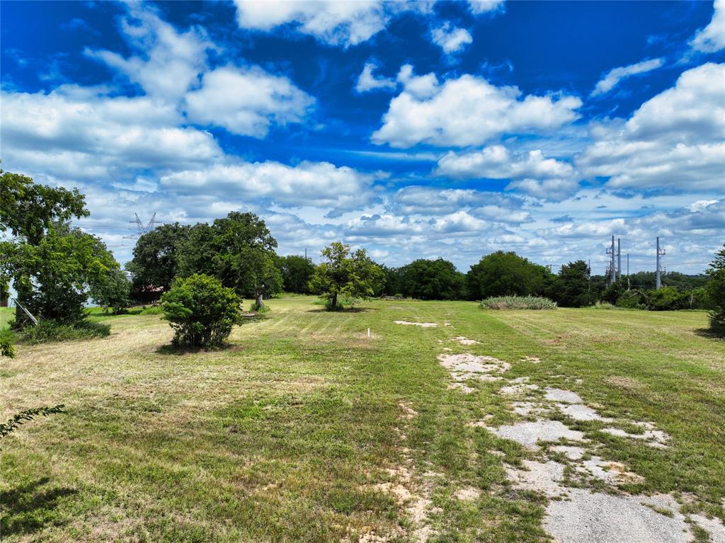 Exceptional 5-acre development opportunity located on highly visible Bankhead Highway in Weatherford, Texas, within one of Parker County’s fastest-growing commercial corridors. Offering excellent access, strong traffic exposure, and city utilities, this property is ideally positioned for a wide variety of development opportunities. This property presents the potential for rezoning to accommodate a broader range of commercial, retail, office, industrial, hospitality, mixed-use, or service-oriented developments, subject to City approval. This flexibility allows developers, investors, and business owners to explore a variety of future uses in a market experiencing significant growth and investment. Strategically located approximately one-quarter mile from Love’s Travel Stop and Blue Beacon Truck Wash and just minutes from the new Costco and Sprouts Farmers Market developments, the property benefits from increasing traffic counts, expanding residential growth, and continued commercial expansion throughout the area. The level, usable acreage provides ample room for building improvements, parking, storage, and future expansion. With convenient access to Interstate 20, downtown Weatherford, and the greater Dallas-Fort Worth Metroplex, this tract offers outstanding visibility and accessibility for a wide range of development concepts. Whether pursuing retail, office, industrial, flex-space, hospitality, service-related businesses, or an investment hold in a high-growth market, this property provides the location, infrastructure, and flexibility to capitalize on Weatherford’s continued expansion. Commercial acreage with city utilities, exceptional visibility, and future development potential within the City of Weatherford is becoming increasingly difficult to find. This is a rare opportunity to secure a strategically located tract in one of North Texas’ most dynamic growth corridors.