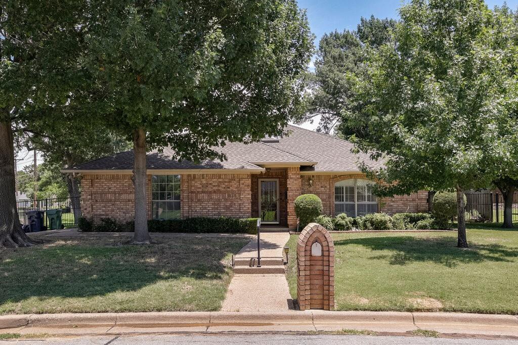 Welcome to this one-of-a-kind home in the desirable Stagecoach Estates Addition and highly regarded Kennedale ISD! Offering 2,078 square feet, this custom-feeling home features 3 bedrooms, 2 bathrooms, and an abundance of character throughout.
Natural light greets you from the moment you enter, thanks to a skylight in the foyer. The split primary suite provides privacy and includes an ensuite bath with separate shower and garden tub, along with an impressive 8' x 6' custom walk-in closet. The spacious living and dining area is perfect for entertaining and features a decorative brick wood-burning fireplace, wet bar, built-in bookcase, sliding glass door to a private side patio, and access to an inviting 11' x 7' sunroom. The sunroom features its own skylight and exterior door leading to the backyard patio and workshop.
The kitchen is truly the heart of the home and unlike anything you'll find in a typical property. It features abundant custom cabinetry, a roll-top desk, built-in bookcases, vaulted ceiling, and a full-length exposed wood beam. A large granite-topped island with breakfast bar and prep sink provides ample workspace, while a floor-to-ceiling decorative brick wood-burning fireplace creates a warm and inviting atmosphere. There's also plenty of room for a dining table between the island and fireplace. Double glass doors provide additional access to the sunroom.
Outside, hobbyists, craftsmen, and DIY enthusiasts will appreciate the detached 20' x 20' workshop complete with electricity, a full-size overhead garage door, and a separate entry door. The oversized patio provides plenty of room for outdoor entertaining, while the garage offers extensive built-in cabinetry for exceptional storage.
If you're looking for a home with personality, character, and unique architectural features that set it apart from the ordinary, this Stagecoach Estates gem is one you won't want to miss!