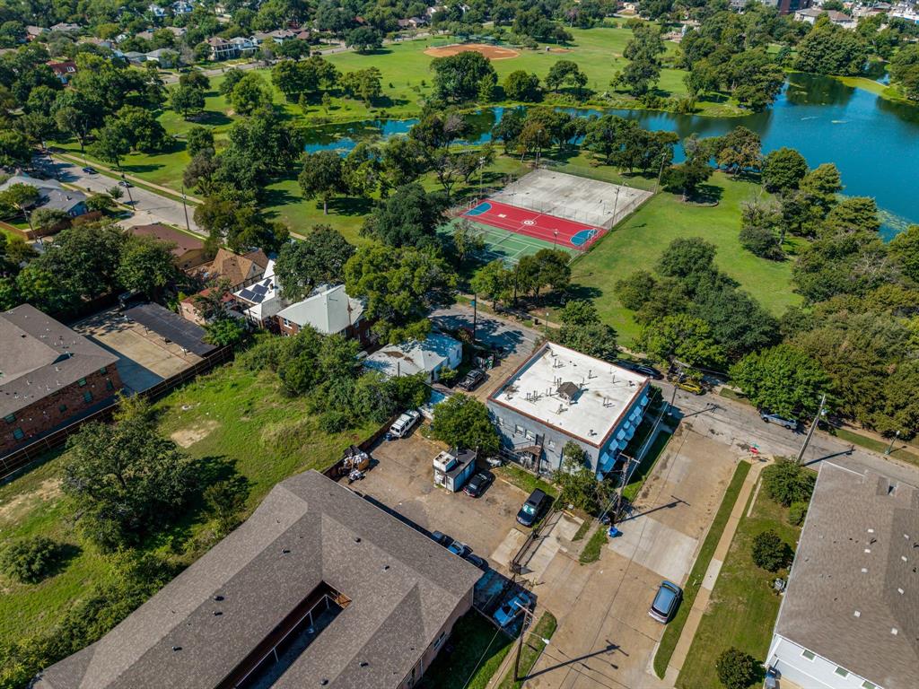 Prime redevelopment opportunity in the heart of the Lake Cliff Historic District. This prominent corner lot offers an unrivaled location directly overlooking Lake Cliff Park, making it one of the most desirable footprints in this historic Dallas neighborhood. The property currently features a 12-unit apartment building consisting of 2 two-bedroom units, 5 one-bedroom units, and 5 efficiencies. The upstairs level contains 2 two-bedroom units, 3 one-bedroom units, and 1 efficiency, while the downstairs level includes 2 one-bedroom units and 4 efficiencies. This property is being sold individually and is priced for land value only. Sold strictly AS-IS, this is a rare chance to develop or restore a significant piece of real estate in a high-demand area with stunning park views and excellent visibility.
