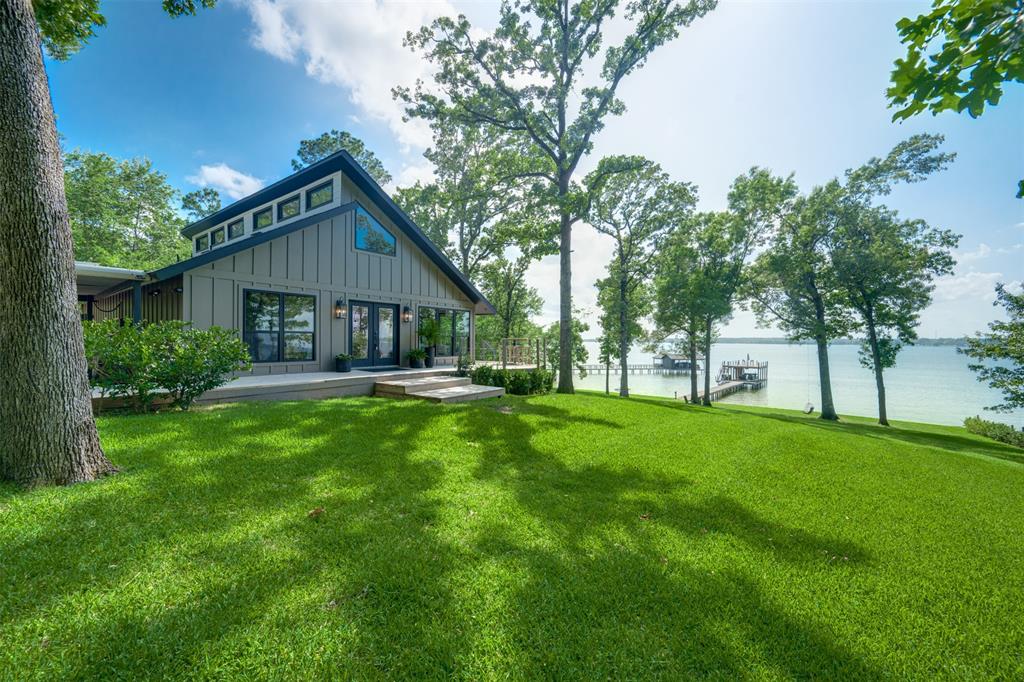 EXTRAORDINARY WATERFRONT PROPERTY SITUATED ON 1.53 ACRES WITH AN ADDITIONAL 1.375-ACRE PARCEL ACROSS THE STREET, OFFERING A RARE COMBINED PACKAGE ON LAKE BOB SANDLIN IN THE HIGHLY DESIRABLE THUNDERBIRD POINT SUBDIVISION. Featuring expansive open-water frontage, panoramic lake views, abundant mature trees, and beautifully maintained grounds, this exceptional property offers the perfect blend of privacy, recreation, and future potential.

The 3-bedroom, 2-bath residence showcases a thoughtfully designed open-concept floor plan with seamless indoor-outdoor living. Expansive decking surrounds both the main home and detached casita, creating multiple spaces for relaxing, entertaining, and taking in the breathtaking natural setting.

The private casita includes a full bathroom and shower, providing comfortable accommodations for guests or extended stays. Additional amenities include a covered carport, private boat slip, boat deck, and direct access to boating, fishing, and watersports. Enjoy spectacular sunsets and stunning lake views from nearly every vantage point on the property.

Residents of Thunderbird Point enjoy access to a private community dock and swimming pool. Conveniently located near shopping, restaurants, and a private airport, this property offers the ideal balance of peaceful lakefront living and everyday convenience.

The additional 1.375-acre parcel provides outstanding opportunities for future development, including guest homes, cabins, recreational use, or investment potential, making this a truly unique Lake Bob Sandlin offering. NOT SOLD SEPARATELY