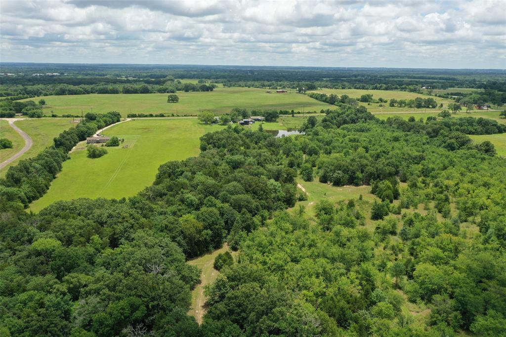 Great opportunity for investment or a dream home in a growing area. The back of the 13.58 acres has large trees, and the front 9.57 acres is grassland or pasture. Direct asphalt road access through the front gate that leads to the entire property. Very rich soil that used to be used for strawberry farming many years ago.