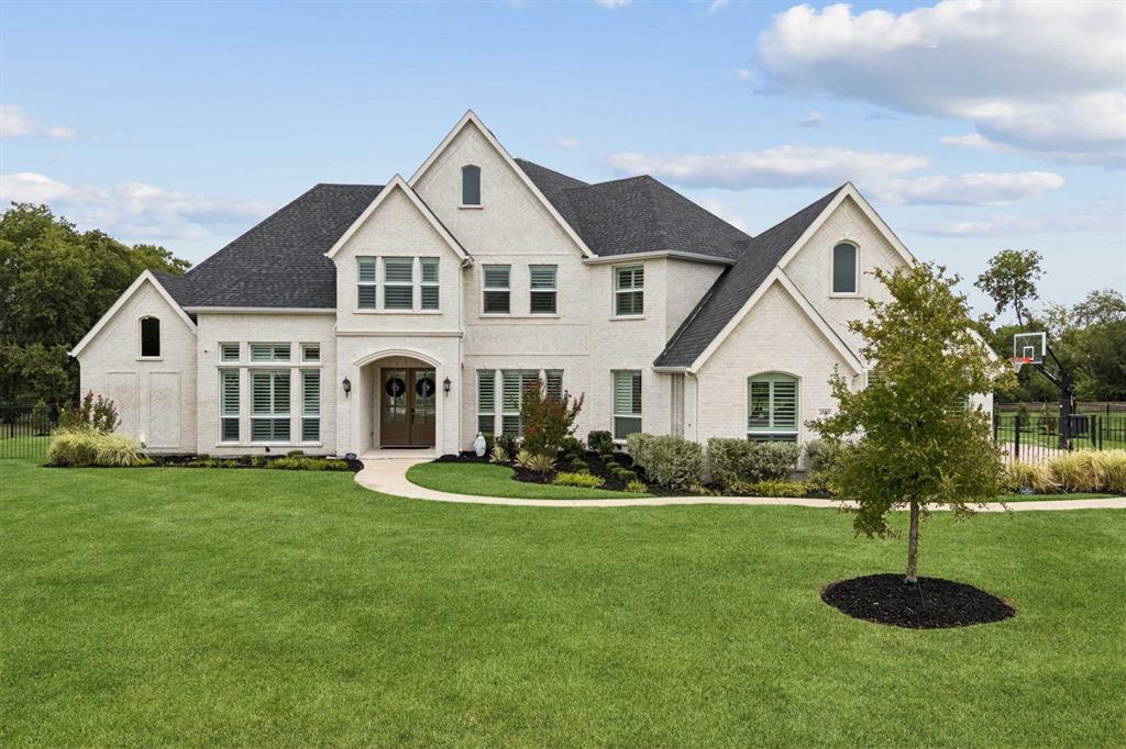 BETTER THAN NEW! This spectacular custom estate offers the pristine perfection of a brand-new home combined with over $100K in immediate post-construction upgrades. Nestled on a premier, private 1-acre lot and zoned for prestigious, top-rated Allen ISD schools, this 5-bedroom, 5.5-bath masterpiece effortlessly blends serene country privacy with modern city convenience. Premium natural white brick, a grand double-door entry and flawless craftsmanship. Soaring ceilings, 7-inch wide custom hardwood floors, and champagne gold fixtures throughout the expansive, light-filled, open concept layout. The chef’s sanctuary kitchen, boasting premium countertops, a striking marble backsplash, and top-tier Electrolux gas appliances. The thoughtful floor plan features two bedrooms on the main level, including a spa-like primary retreat with dual shower heads, and three additional large bedrooms upstairs have their own private bathrooms. This dream home offers a massive game room loft alongside a fully wired media room ready for your ultimate movie nights. The luxury extends outdoors to a sprawling backyard secured by a custom iron gate, offering mature afternoon shade, professional landscaping, and a high-end Ruffhouse playset complete with built-in cooling misters and water cannons. High-tech and mechanical upgrades abound, including app-controlled smart security and climate systems, a whole-home water filtration and softening system, and an oversized 3-car garage with pristine epoxy floors and bonus gym space. Skip the stress and time to build new - this turnkey luxury estate is 100% complete and ready for immediate move-in.
