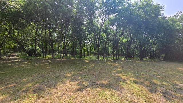 Desirable 3.7 acres with WATER METER in secluded area of Trenton High Meadows Phase 1. This beautiful property offers trees galore with a creek on the back side that allows this scenic property to be the platform to your custom dream home.  This is a deed restricted area just minutes from the Trenton High School and quiet area of the subdivision. No Mobile Homes allowed. Septic is required and there is a water meter in place as shown in pics.  Electricity is available. Convenient to McKinney, Bonham, Sherman, Leonard and Trenton for living amenities and shopping needs.  Take a country drive and walk the property, bring your contractor to see just where you might decide to call home!