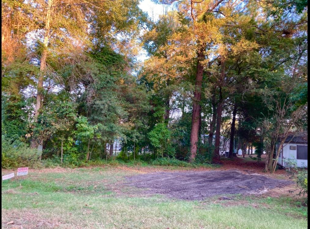 262 E. Walnut Trail   7928 sq. feet    .182 acres
This lot is Located at Callender Lake which is 25 min. SE of Canton and 30 min west of Tyler in a gated community.  Lot is 77 feet wide at the front, and 98 feet at the back and around 90 feet on each side.   Property backs up to a wide drainage area between two homes creating an expansive partial water view and has beautiful tall pine trees.  The right side is completely cleared and leveled and ready for a new home.  The area with the trees on the left is freshly cleared of vines so you can walk through and make your plans.  Lot has a power pole and water meter box plumbed but no meter.  Original seller said it has septic and there is an old trailer tie down in the ground but we have not located the septic.  Property is being sold as if there is no septic.  Hickory hills allows mobile homes and RV's but they must be less than 10 years old when brought into the community.  Mobile homes and site built homes must be 600 sq. feet or larger.  A septic tank is required if you bring in a home or build one.  Located on the 365 acre spring fed Callender Lake makes this a fun place to be.  The lake has great fishing, swimming, and boating.   There is a boat ramp, fishing pier, community pool, children's park, pavilion with picnic tables, and restroom and shower facility located next to the pool.  Come see this great lot today and start living the LAKE LIFE.