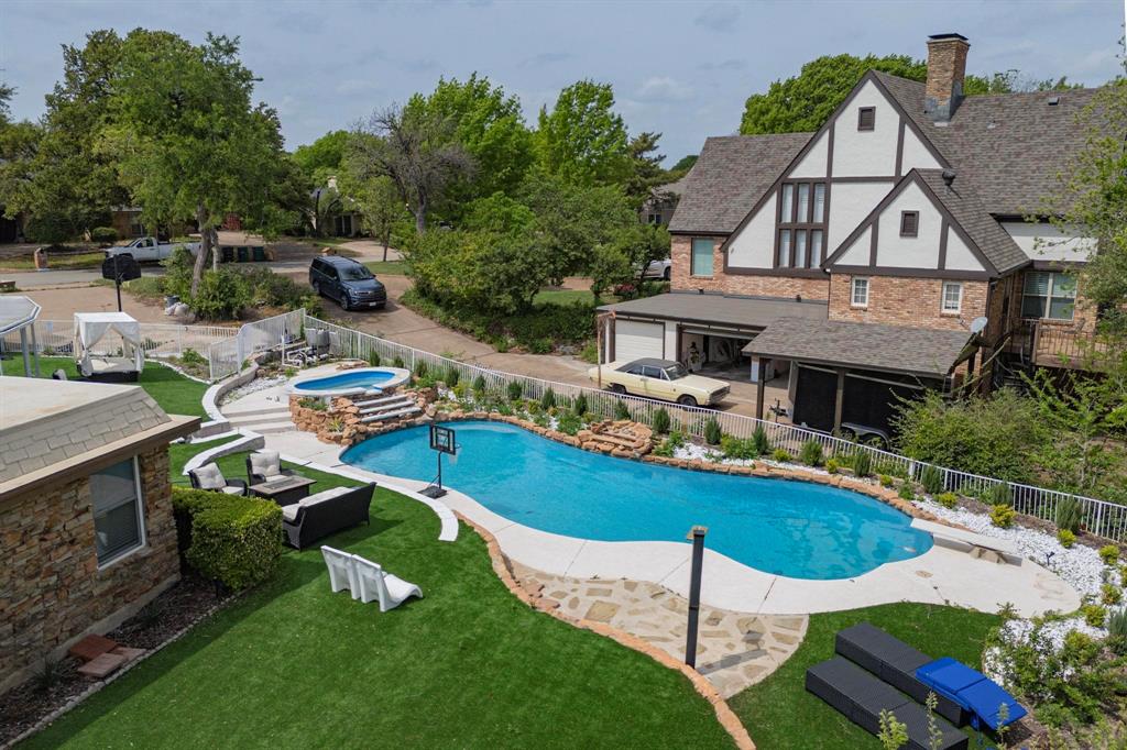 THIS HOME COMES WITH AN EXCLUSIVE FINANCING OFFERING THAT LOWERS YOUR RATE A FULL 1% WITH PREFERRED LENDER...Impeccable, fully remodeled and unique estate in a serene, tree lined community! This 4 bed 3 and a half bath masterpiece features a stunning floor plan highlighted by a living room with vaulted ceilings and a floor to ceiling stone fireplace. Ascend the custom spiral staircase to the ultimate private retreat: a full floor primary suite with its own fireplace, private balcony overlooking the pool, and an open landing overlooking the living area. The spa like primary bath offers a large shower with a rain head and a walk in closet with a dividing wall for dual his & hers vanities.
The gourmet kitchen boasts all new stainless appliances, double ovens, and a center island, flanked by a casual breakfast nook and a massive formal dining room. The 3 bedrooms include one with an ensuite bedroom with a classic clawfoot tub and two bedrooms with a Jack and Jill bath. Functional extras include an oversized laundry room with sink and a dedicated home gym or flex room near the garage.
Outside, enjoy a maintenance free oasis with high end AstroTurf in both the front and back yards. The resort style backyard features a large covered patio, a deep diving pool with an attached hot tub, and lush professional landscaping. Experience luxury living with zero lawn care hassle! And a bit of Instant Equity! Seller has a recent appraisal on file and has priced this home below appraised value. All information is deemed reliable but not guaranteed. Buyer & buyers agent should confirm all needed information. No survey is available, buyer will need to purchase.