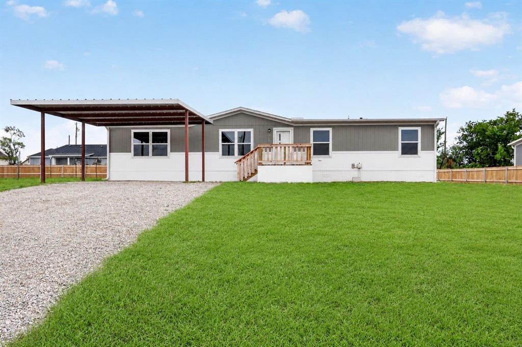 Enjoy the best of comfortable living and functional design in this spacious 4 bedroom home situated on a 0.26-acre lot. Step inside to a welcoming living area that flows naturally into the heart of the home, creating a layout that feels open, connected, and built for gathering. The kitchen offers both style and functionality making it the perfect place to cook, host, and enjoy with a center island, decorative backsplash, refrigerator, dishwasher, and oven range. Sliding glass doors are located directly behind the dining area and open to the covered 10' x 18' rear porch, extending your living space outdoors and blending indoor comfort with fresh air and relaxation. The primary suite offers an en-suite bathroom and a large walk-in closet. Three additional bedrooms and a second full bathroom provide flexibility for family, guests, a home office, or hobby room. A spacious utility room adds convenience with room for a full-size washer and dryer and added storage space. Outside, enjoy the custom 8' x 8' front deck and 20' x 20' carport. Don't miss the opportunity to make this property yours, schedule your private showing today!