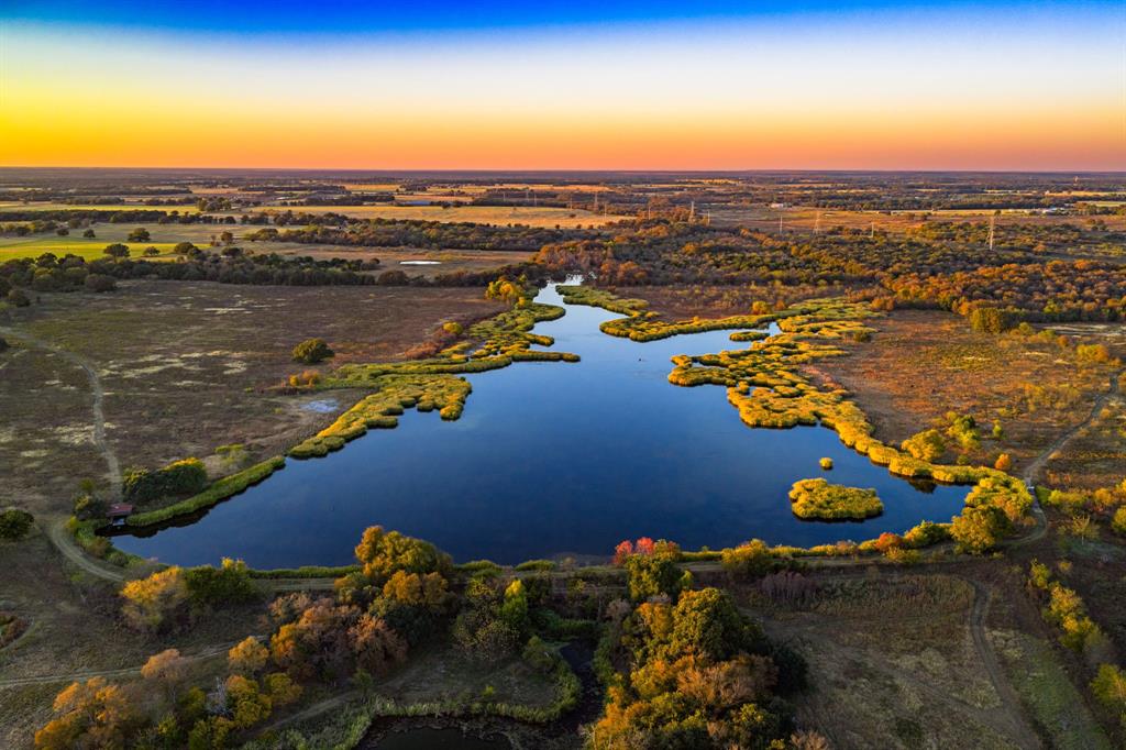 Patten Springs Ranch is a rare large acreage offering in Central Texas, defined by exceptional water, diverse native habitat, and one of the most impressive spring-fed lakes currently on the market. Located in Aquilla, Texas, the ranch spans 843 acres and features a stunning 13-acre crystal-clear spring-fed lake, an additional 5-acre lake, and 10 stock tanks, providing outstanding water distribution across the property. The land offers a balanced mix of open pasture, rolling terrain, and mature hardwood cover, making it ideal for family recreation, hunting and fishing, cattle operations, and long term land investment. Wildlife is abundant throughout the ranch, including whitetail deer, feral pigs, Rio Grande turkey, dove, and waterfowl, with ducks and geese heavily utilizing the lakes and ponds. A unique feature of the property is the presence of river otters in the main lake, a rare sight in Texas and a strong indicator of a healthy ecosystem. The ranch is exceptionally well watered with multiple springs, spring fed surface water, and consistent flow rarely found on a property of this size in Central Texas. Patten Springs Ranch is conveniently located just 25 minutes from Waco, approximately one hour and fourteen minutes to DFW, two hours to Austin, and roughly three hours to Houston and San Antonio, offering excellent accessibility while still providing privacy and seclusion. Oncor is the electric provider in the area, and the property features approximately 7,700 feet of frontage on FM 933 and 5,500 feet of frontage on Patton Lake Road.