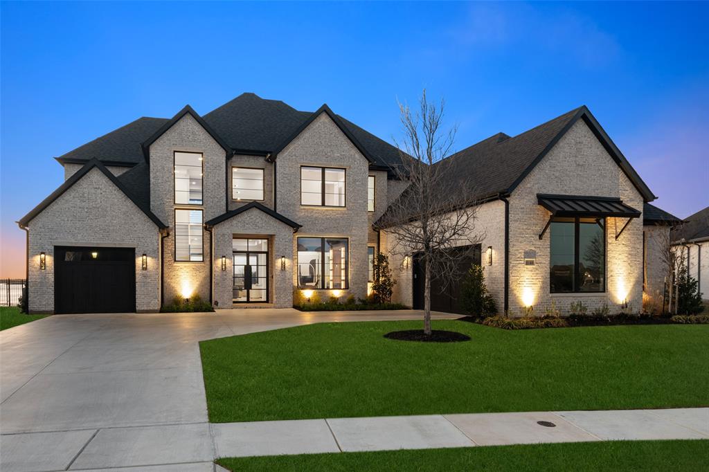 A rare opportunity for a truly one-of-a-kind custom residence on over 0.5 acres with breathtaking lake views in the prestigious lakeside community of The Tribute. Thoughtfully designed to capture the beauty of Lake Lewisville, this architecturally striking home features expansive windows, seamless indoor-outdoor layout that maximizes natural light and panoramic water views throughout. The sleek modern design balances warmth and timeless finishes creating an inviting yet sophisticated atmosphere throughout. Designer details and luxury upgrades at every turn including light wood floors that flow throughout, striking architectural accents, and designer lighting. The chef’s kitchen serves as the heart of the home, showcasing Monogram appliances, custom cabinetry, an oversized island, and a fully equipped prep kitchen designed for effortless entertaining. The home’s thoughtful design continues with multiple living spaces, private ensuite bedrooms, spacious media room, dedicated home gym, and a tech room. Step outside to an extraordinary backyard retreat featuring resort-style pool, covered living area with outdoor kitchen, grill, sink, and refrigerator. The oversized yard and direct lake access create an unmatched outdoor experience with sweeping lake views that serve as the perfect backdrop for entertaining or relaxing with family. Located in the Waterford Point village of The Tribute, offering a true lakeside lifestyle surrounded by nature with miles of scenic walking and biking trails designed to get the whole family outside. Community amenities include 3 resort style pools, pickleball courts, a dog park, and playgrounds. Highly anticipated marina will soon provide even greater access to the lake, enhancing the exceptional lakeside living experience. A rare blend of custom architecture, luxury design, and unmatched lake views, this home offers a truly extraordinary lifestyle opportunity in one of North Texas’ most sought after communities.