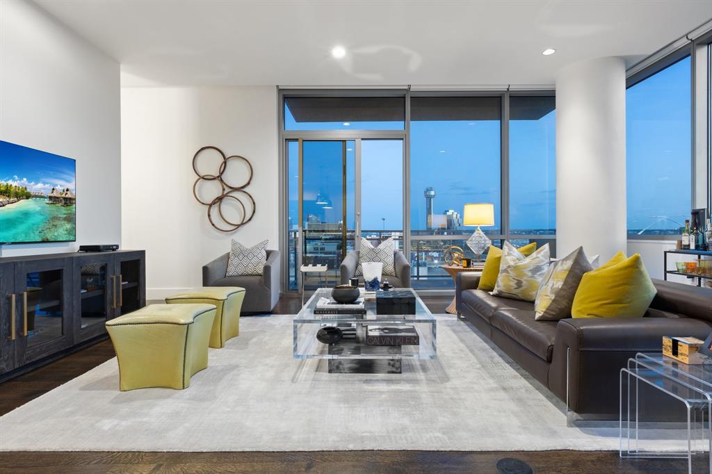 Experience elevated urban living in this 11th-floor residence at The House Condos, the iconic Starck & Yoo designed high-rise in the heart of Victory Park. Floor-to-ceiling windows frame sweeping views of Downtown Dallas, Reunion Tower, and the Margaret Hunt Hill Bridge, creating a striking skyline backdrop by day and night.

The thoughtfully designed layout features two living areas, with the second offering flexibility as a den, study, or office. The interior showcases Sub-Zero, Wolf, and Asko appliances, white oak hardwood floors, and elegant Crema Marfil marble countertops, backsplash, and bath. Refined details include 10-foot ceilings, museum-finish walls, and motorized window shades, complemented by a custom bedroom closet offering exceptional storage. One dedicated parking space.

Residents enjoy resort-style amenities including a 130-foot saline infinity pool, spa, private cabanas, two grilling areas, dog park, owners’ lounge, conference room, guest suite, and fully equipped fitness center. Full-service living is completed with concierge, valet, package delivery, and 24-hour security steps from Dallas’ premier dining, sports, and cultural destinations.