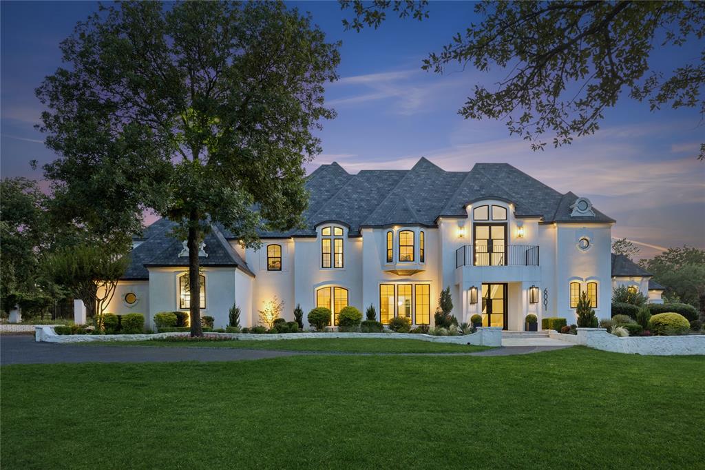 A stunning complete remodel within the prestigious 24hr guard, gated golf community of The Estates of Tour 18, with seller adding a spectacular sport court and privacy landscape with acceptable contract! Sitting perfectly on the 11th green that enjoys year round entertaining options, enjoyment and privacy and strategically designed for true multi-generational living. European in style with all the latest luxury design features that will exceed all expectations. Thoughtfully curated with exquisite finishes, precision workmanship and an ideal layout that can comfortably satisfy all life stages beautifully. Updates include: complete exterior remodel with stucco over brick, added larger columns, custom wrought iron balcony, 2 sets of steel entry doors, energy efficient windows, level 5 museum finished walls, 4 XL Navien tankless smart water heaters, 7 inch solid oak select grade hardwoods throughout home, custom cut herringbone pattern downstairs, complete re-envisioned kitchen now open to all the living spaces with solid white oak cabinetry, Tai Mahal quartzite countertops, full Wolf-Sub Zero appliance package with Restoration Hardware lighting. Glass wine room w glowing Cristallo quartzite + separate wine cellar w glass bottle cradle cable system, media features a 2nd kitchen w Cristallo countertops, dishwasher, Subzero wine fridge, ice maker. The private primary includes spa bath experience, a separate wellness room or extra office, coffee bar space + thoughtfuly designed large closet. Convenient first floor hidden in-law suite with dreamy bath, a convenient dog grooming room, cedar garage doors installed w Wifi controls and LiftMaster jackshift side mount openers. The extensive backyard is an oasis of it's own including fire pit, putting green, a pool cabana with dramatic waterfall, 4 grill stations with elevated exterior lighting and permanent Govee lighting. The stately grounds could also manage full size tennis court. Sellers entertaining all offers this summer!