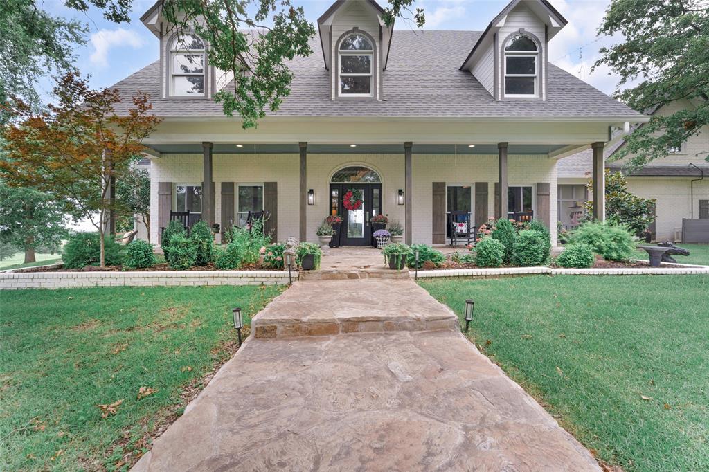 A gated entrance, with pipe fencing, leads to a long, winding concrete driveway & recently remodeled 2-story home on 58-plus acres! Take in amazing views from every window of the picturesque countryside. Inside, you'll find 2 primary bedrooms, one on each floor & 3 living areas with a great room & den downstairs & 1 living room upstairs. The kitchen includes commercial-grade gas range, island, granite countertops, walk-in pantry, & more! All 3 bedrooms have a bathroom plus half-bath downstairs. Find plenty of parking with a 2-car carport & 36x33 detached garage with overhang, workshop, & 2 overhead doors. There is an attached 2nd shop with 2 doors & 3 stalls. A 3rd equipment shop, 40x30x14, could also be used as a hay barn or RV storage. A 5-stall horse barn w-tackroom & washrack also included. An outdoor arena, round pen, chicken coop or dog house (HVAC, water & Elect), 1-ac fishing pond, stock pond, greenhouse, storm shelter, & generator. A stunning setting with lots of amenities!