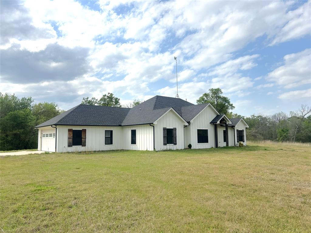 This 3 bedroom, 2.5 bath home sits on just under 7 acres and offers a private setting tucked behind the trees. Built in 2020, the home features stained concrete floors, high ceilings, and granite countertops. The primary suite includes dual walk-in closets, a separate shower, dual sinks, and a large tub. The back patio provides space for relaxing or entertaining. Conveniently located near I-30, the property offers quick access to downtown while still providing a quiet, country feel.