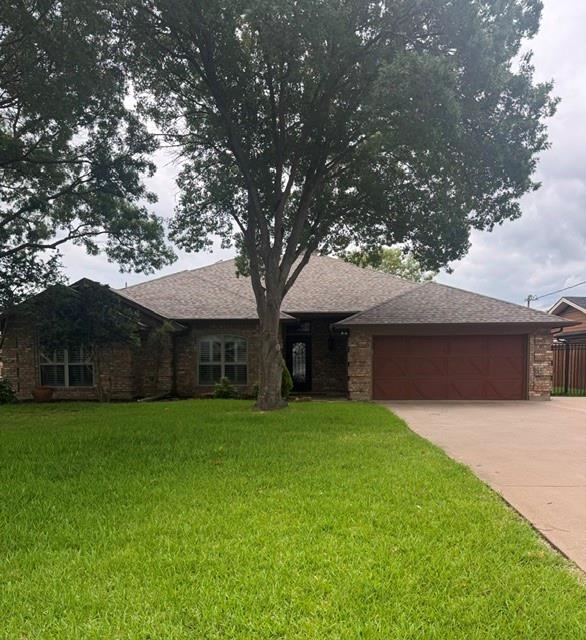Beautifully updated lakefront home in The Shores addition of Granbury, no City Taxes, outside City limits, no HOA! Can be an Airbnb! This move in ready property features wood look ceramic tile flooring, fresh interior and exterior paint, and plantation shutters throughout. The open layout offers vaulted ceilings and abundant windows, filling the home with natural light and showcasing peaceful lake views. The spacious kitchen is perfect for entertaining with new quartz countertops, stainless steel appliances, and a large island. A reverse osmosis water drinking system adds extra convenience. The primary suite includes a newly updated bath with quartz countertops, an oversized shower, and a lighted vanity mirror. Step outside to a 21x18 covered porch under a cedar pergola that is ideal for relaxing or entertaining lakeside. The impressive 18x35 dock features a 10.5x25 boat slip, 30-ft touchless remote-controlled boat cover, 4,000 lb boat lift with V hull cradle, and a 4.75 kW solar system. Additional upgrades include a new HVAC system, a roof just 6 years old, and a sprinkler system powered by a 220V 1.5 HP pump with low-cost lake water usage approx. $53 per year. Enjoy lake living at its best with modern updates, energy-efficient features, and exceptional outdoor amenities!