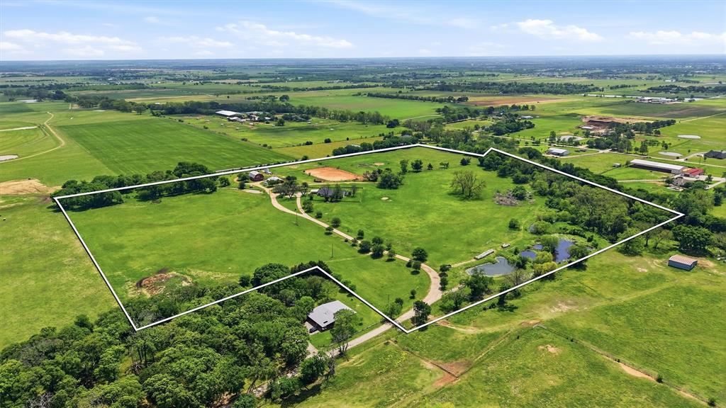 Nestled at the end of highly sought-after Debbie Lane in Pilot Point, Texas, a rapidly up-and-coming city, this 43.88-acre property is a rare gem in the booming growth corridor. Currently ag-exempt and fully cross-fenced, the land features sandy loam soil—ideal for grazing, equine, or cattle. At the heart is a sprawling 3,682 sq. ft. ranch-style home with 4 bedrooms and 3 baths—perfectly blending comfort and charm. The property also includes a barn, an outdoor riding arena, and additional acreage for expansion. City water and electricity are available, and city sewer runs up and down Debbie Lane, providing even more development potential. Just moments from Highway 377, across from Brookshire Brothers Grocery, and close to banks, the high school, a variety of restaurants, and the ever-expanding Highway 455, Pilot Point is a city on the rise, offering easy access to the Metroplex. This is a phenomenal investment opportunity in a prime corridor—don’t miss out!