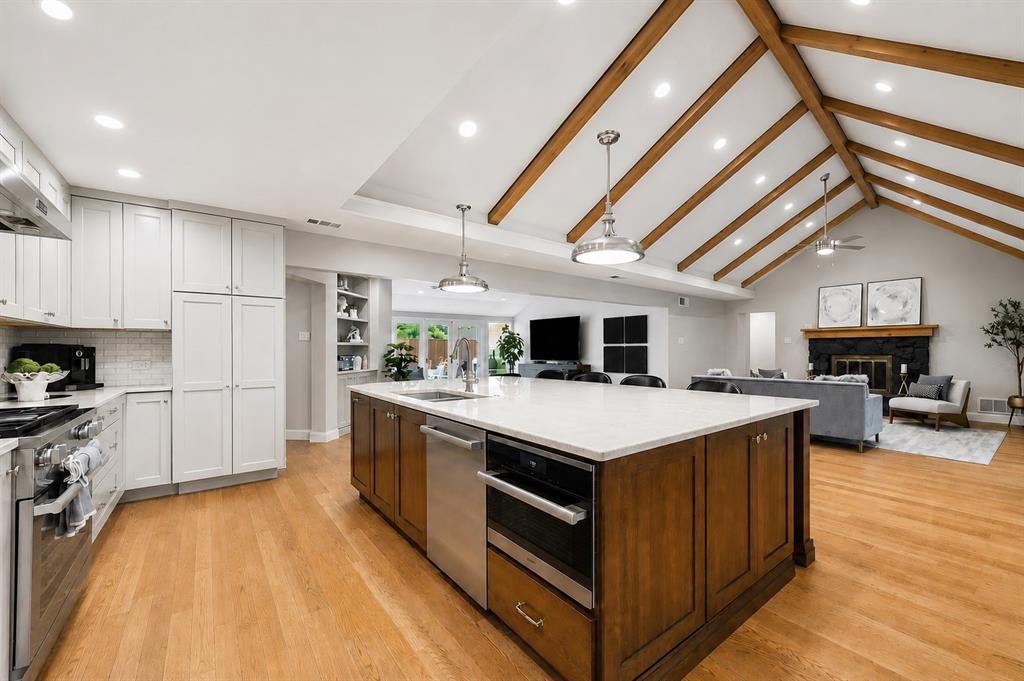 This beautifully remodeled single-story home combines style, comfort, and thoughtful design in a highly desirable location within the private school corridor. Offering 5 bedrooms and 3.1 baths, the flexible floor plan includes a spacious fifth bedroom that can easily serve as a game room, media room, or additional living space. Spacious rooms throughout create an open, inviting feel, while rich wood floors add warmth and character. Designed for both everyday living and entertaining, the open-concept layout centers around a stunning kitchen featuring a large island with breakfast bar seating, professional-grade range, built-in refrigerator, premium Miele appliances, and abundant cabinets and workspace. The laundry room is equally functional with built-in cabinetry and a sink. The primary suite provides a true retreat with two walk-in closets and a spa-inspired bath complete with a freestanding soaking tub and frameless glass shower. Outside, enjoy your own private backyard oasis with a pool and spa surrounded by attractive landscaping and low-maintenance xeriscape design. Additional features include Pella windows, a gated driveway, and an oversized 3-car garage. This home offers the perfect blend of luxury finishes, functionality, and casual living. Easy access to I-635, Dallas North Tollway, quality restaurants, shopping, and the new Mavericks stadium site.