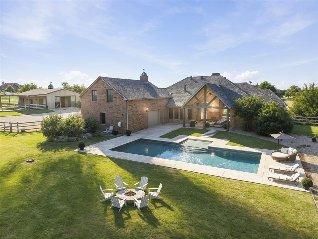 This beautifully updated, like-new home offers nearly 3,800 square feet of fresh, bright living space and sits on a rare 4+ acre horse property in High Trinity Ridge Estates in Aubrey. Freshly painted throughout—including all walls, ceilings, trim, doors, and door jambs—with all new lighting, the home features four large bedrooms, a dedicated office, vaulted ceilings, a fireplace, a walk-in pantry, and a spacious master bedroom with its own private sitting area. The updated three-quarter bath includes a new vanity and mirror. Outside, enjoy a covered patio with a second fireplace and a pool. This exceptional equestrian property allows up to four horses and boasts sandy loam soil, a top-quality 4-stall barn, loafing shed, covered trailer parking, a riding pad, and spacious pastures. Ideally located just north of Lake Lewisville and minutes from Denton, the property includes two separate lots with two distinct tax ID numbers, offering the new owner the ability to build a second home for family or resale.