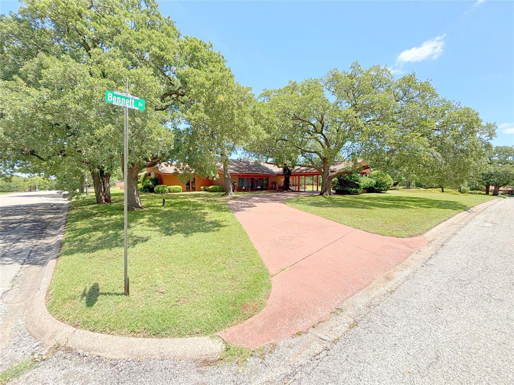 Welcome to this beautiful 3-bedroom, 2.5-bath, 2 car garage, home situated on a lush, tree-filled 1.5 acre lot. Nestled in a highly desirable neighborhood, this property boasts timeless elegance and modern comfort throughout.
From the circular driveway and porte-cochère to the mature landscaping and inviting front entry, every detail reflects pride of ownership. Inside, you’ll find an expansive formal living room and a warm, open-concept layout that connects the breakfast area, den, and kitchen—perfect for everyday living and entertaining.
The home features oversized windows offering serene views of both the front and backyards, flooding the interior with natural light. Unique brick accents, rich wooden beams, vaulted ceilings, and a cozy rock fireplace with gas logs create a den that’s both rustic and refined. The custom kitchen showcases exquisite teak and copper cabinetry that blends beauty and function. Additionally there is a laundry room with a kitchenette.
Enjoy year-round comfort in the sunroom, or retreat outside to the separate office—ideal for remote work or creative pursuits. The property also includes a large storage-workshop space. an outdoor fireplace, thoughtfully designed sitting areas with walkways, a full sprinkler system, and impeccably maintained landscaping that makes every inch of the property feel like a private retreat.
This one-of-a-kind property combines character, comfort, and convenience - schedule your showing today!