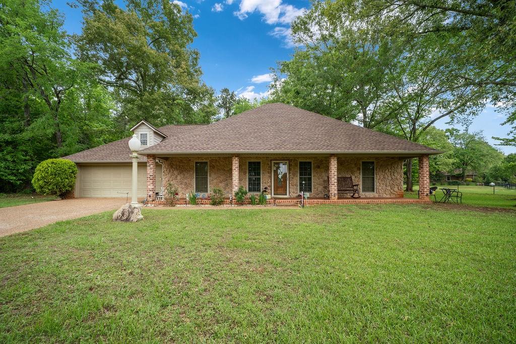 Tucked away on a quiet cul-de-sac street in highly sought-after Bullard ISD, this beautifully maintained 3-bedroom, 2-bath home offers the perfect blend of space, privacy, and everyday comfort. Set on a generous 1.06-acre lot with a view of Lake Palestine from the front porch, the property also enjoys close proximity to the lake for easy access to boating, fishing, and year-round recreation. Inside, the 2,170 square foot layout is both functional and inviting, featuring a split floorplan, spacious living area anchored by a cozy wood-burning fireplace, and a versatile flex space ideal for a home office, playroom, or fitness room. The kitchen offers abundant storage with ample cabinetry and workspace, making it as practical as it is welcoming. The oversized primary suite provides a true retreat, complete with a double vanity bathroom, walk-in shower, and a large walk-in closet. Built in 2002 and thoughtfully cared for, the home also includes a recently replaced roof just one year old, generous secondary bedrooms, and a reinforced laundry room designed as a safe room. The garage provides additional storage, while the expansive backyard offers endless potential for entertaining, gardening, or future improvements. Enjoy quiet relaxation on the large covered front porch with peaceful surroundings and subtle lake views. This is a rare opportunity to combine space, comfort, and location just minutes from Lake Palestine and local amenities. Call to schedule your showing today!