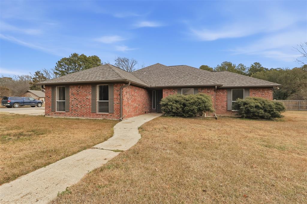 Welcome home to this beautifully updated 3-bedroom, 2-bath residence located on a large corner lot in the desirable Quail Hollow Addition. This move-in-ready home features new windows, fresh paint, and new flooring throughout, offering a bright and modern feel from the moment you step inside. The inviting living area is anchored by a cozy wood-burning fireplace, perfect for relaxing evenings. Outdoors, enjoy a private fenced backyard complete with a back deck, ideal for entertaining or unwinding. With thoughtful updates and a spacious lot, this home combines comfort, privacy, and convenience in a sought-after neighborhood.